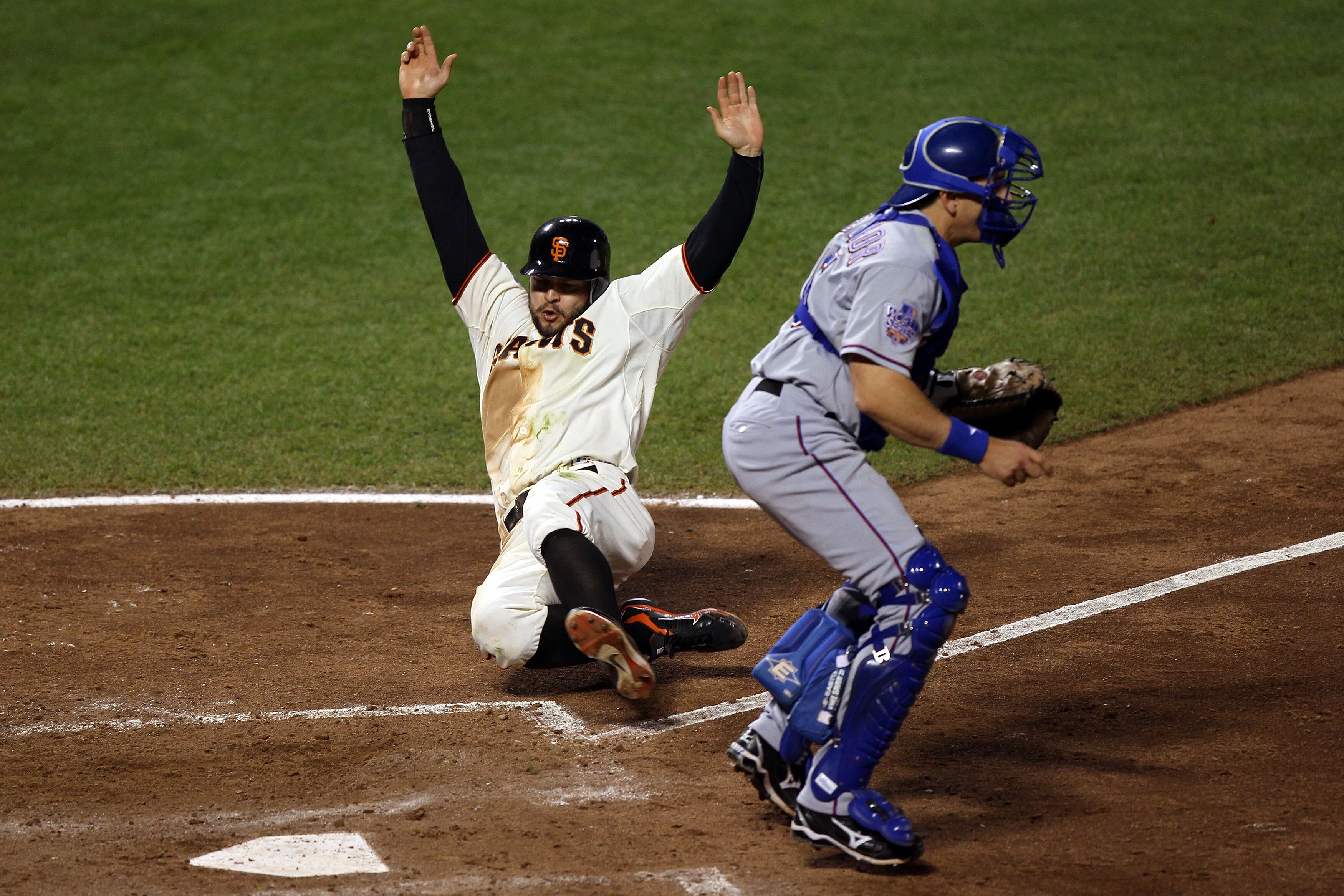 SAN FRANCISCO - OCTOBER 28:  Cody Ross #13 of the San Francisco Giants slides home safely to score a run in the seventh inning before the tag of Matt Treanor #15 of the Texas Rangers in Game Two of the 2010 MLB World Series at AT&T Park on October 28, 201