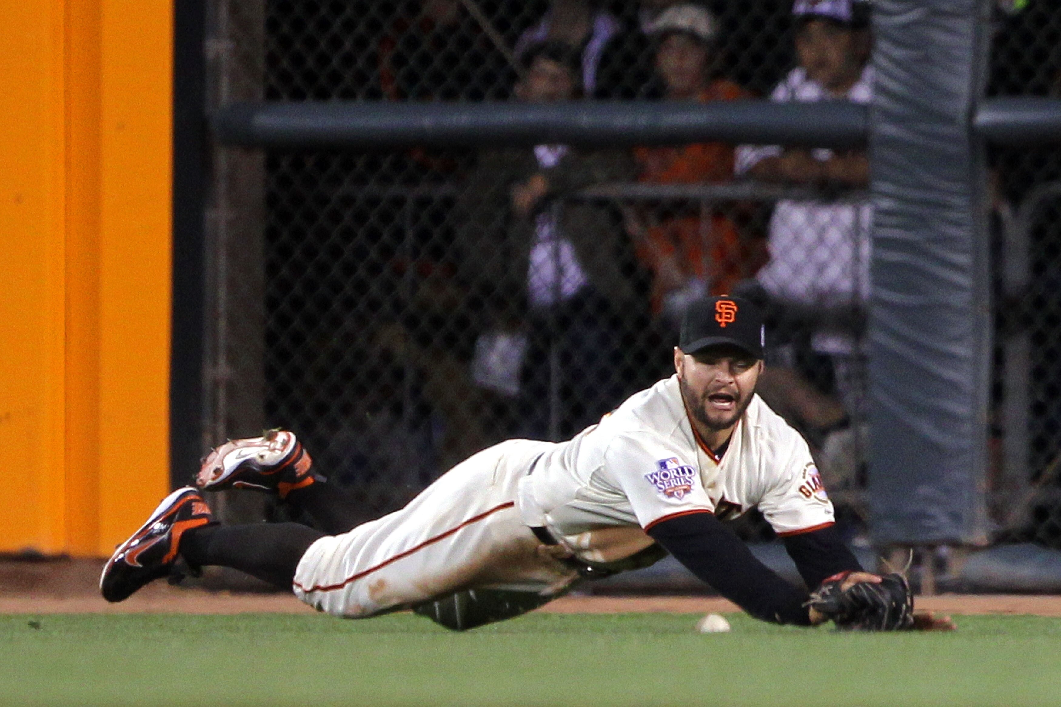 SAN FRANCISCO - OCTOBER 28:  Cody Ross #13 of the San Francisco Giants is unable to catch a ball hit by Josh Hamilton #32 of the Texas Rangers leading to single for Hamilton in the sixth inning of Game Two of the 2010 MLB World Series at AT&T Park on Octo