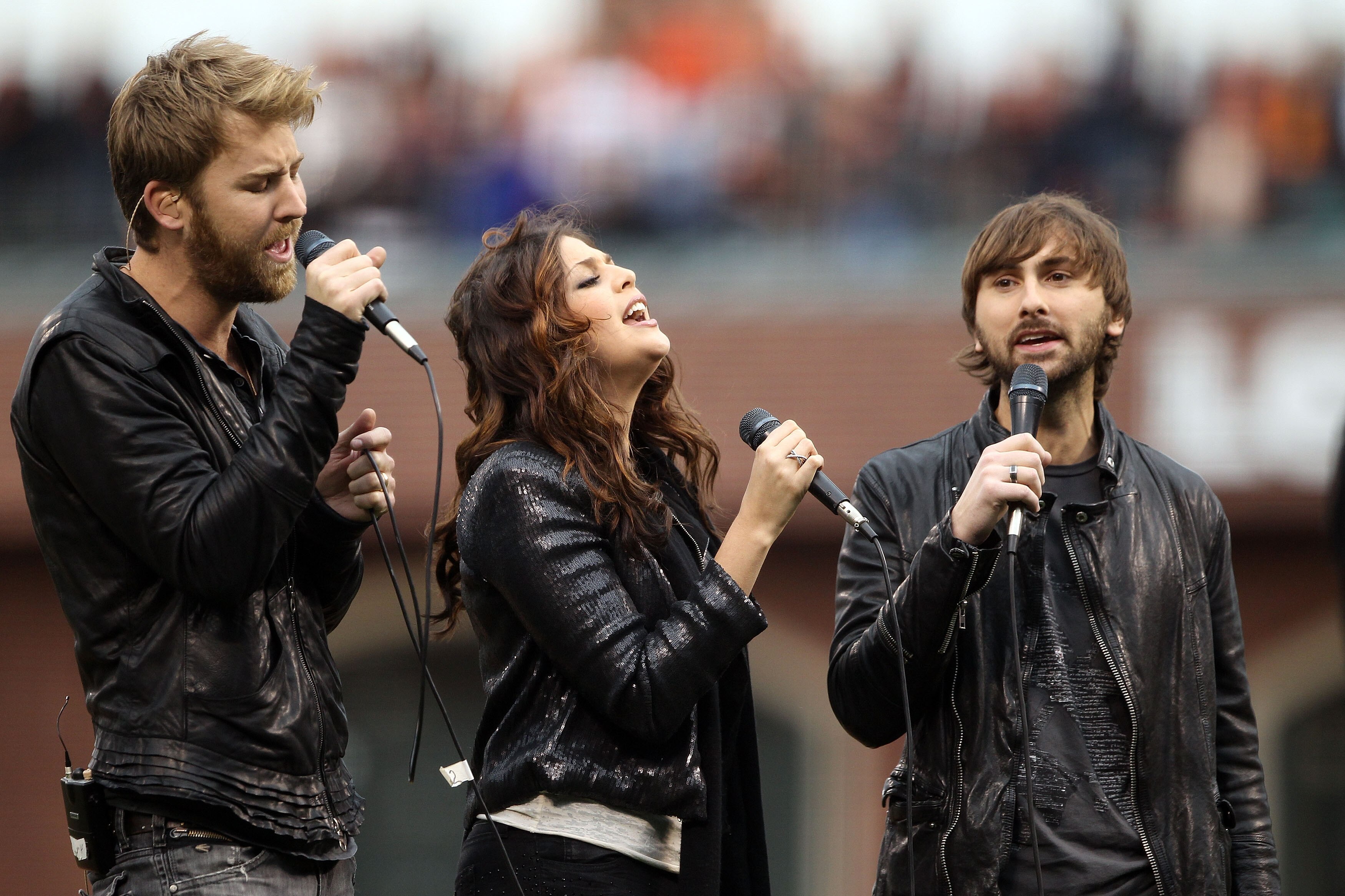SAN FRANCISCO - OCTOBER 28:  Charles Kelly (L), Hillary Scott and Dave Haywood (R) of Lady Antebellum sing the national anthem before the start of Game Two of the 2010 MLB World Series between the San Francisco Giants and Texas Rangers on October 28, 2010