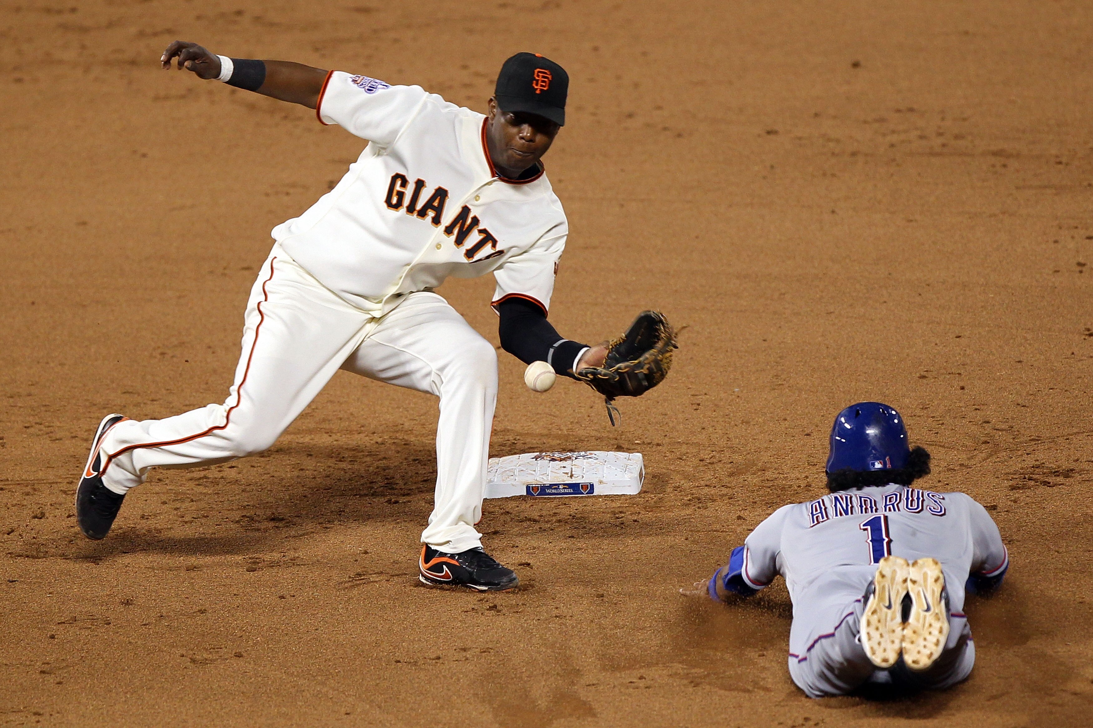 SAN FRANCISCO - OCTOBER 28:  Elvis Andrus #1 of the Texas Rangers steals second base as the ball gets away from Edgar Renteria #16 of the San Francisco Giants in the eighth inning of Game Two of the 2010 MLB World Series at AT&T Park on October 28, 2010 i