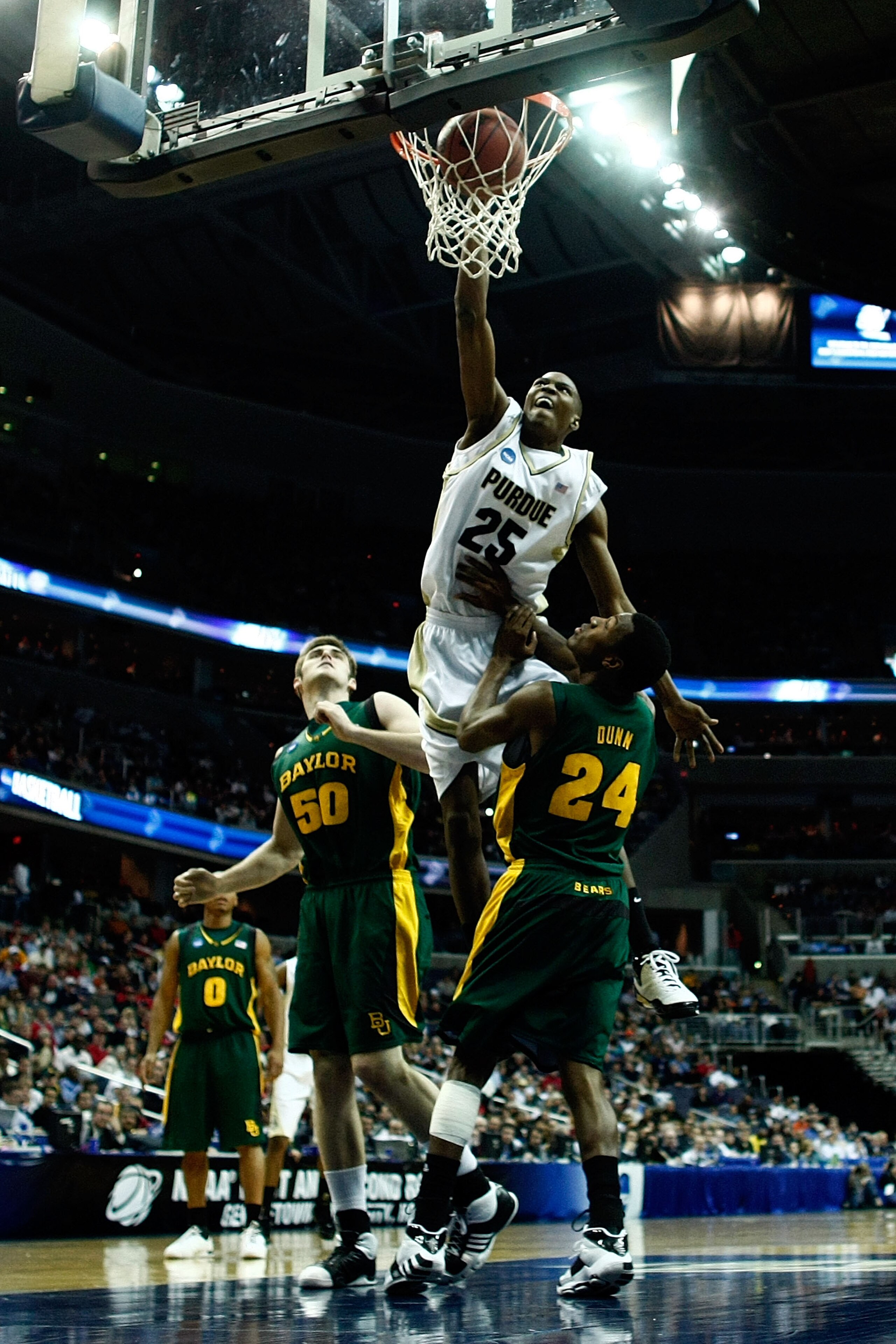 WASHINGTON - MARCH 20:  JaJuan Johnson #25 of the Purdue Boilermakers dunks against Josh Lomers #50 and LaceDarius Dunn #24 of the Baylor Bears during the first round of the West Regional as part of the 2008 NCAA Men's Basketball Tournament at the Verizon