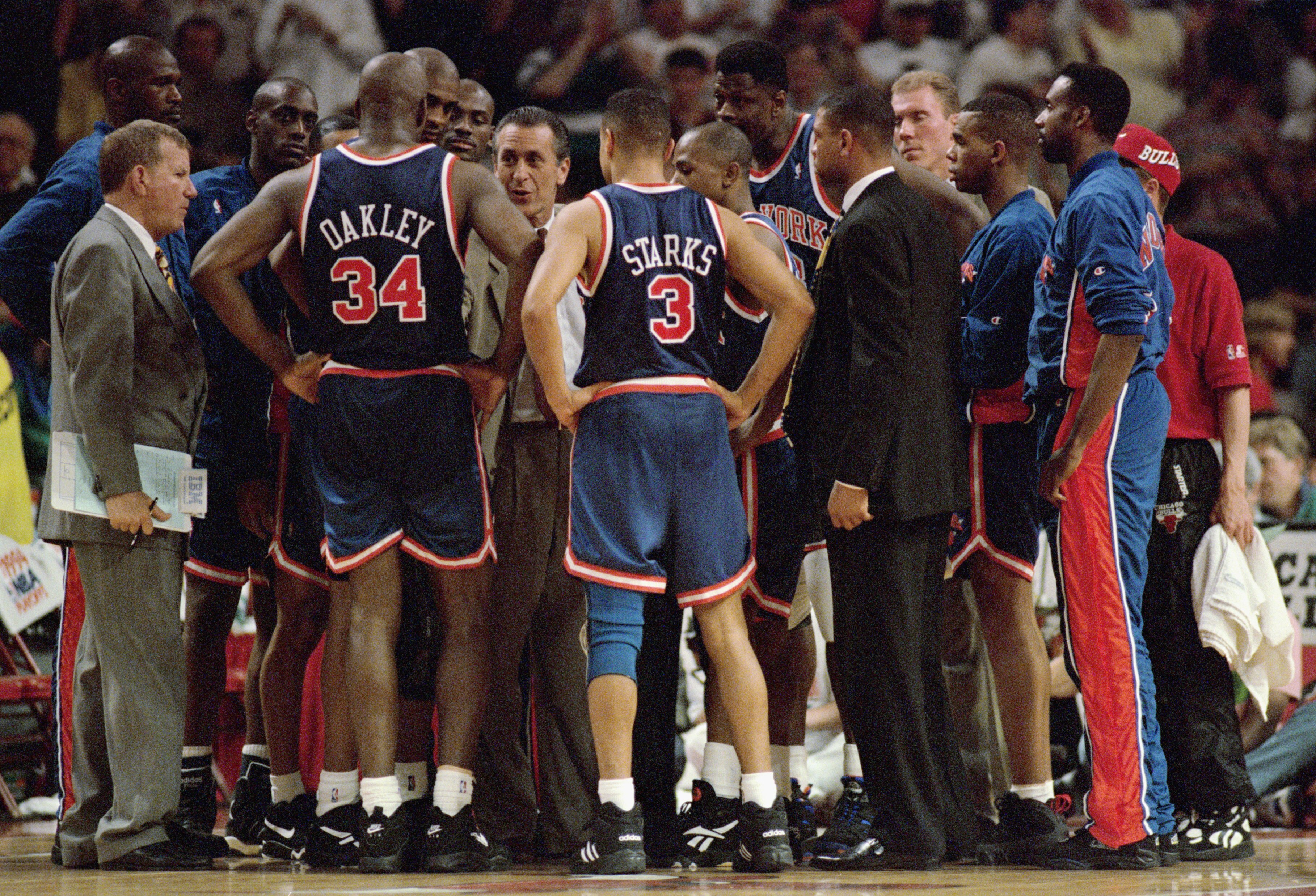 CHICAGO - MAY 15:  In a team huddle, head coach Pat Riley directs John Starks #3 and Charles Oakley #34 of the New York Knicks during the Eastern Conference Semifinals game in the 1994 NBA Playoffs against the Chicago Bulls at the United Center on May 15,