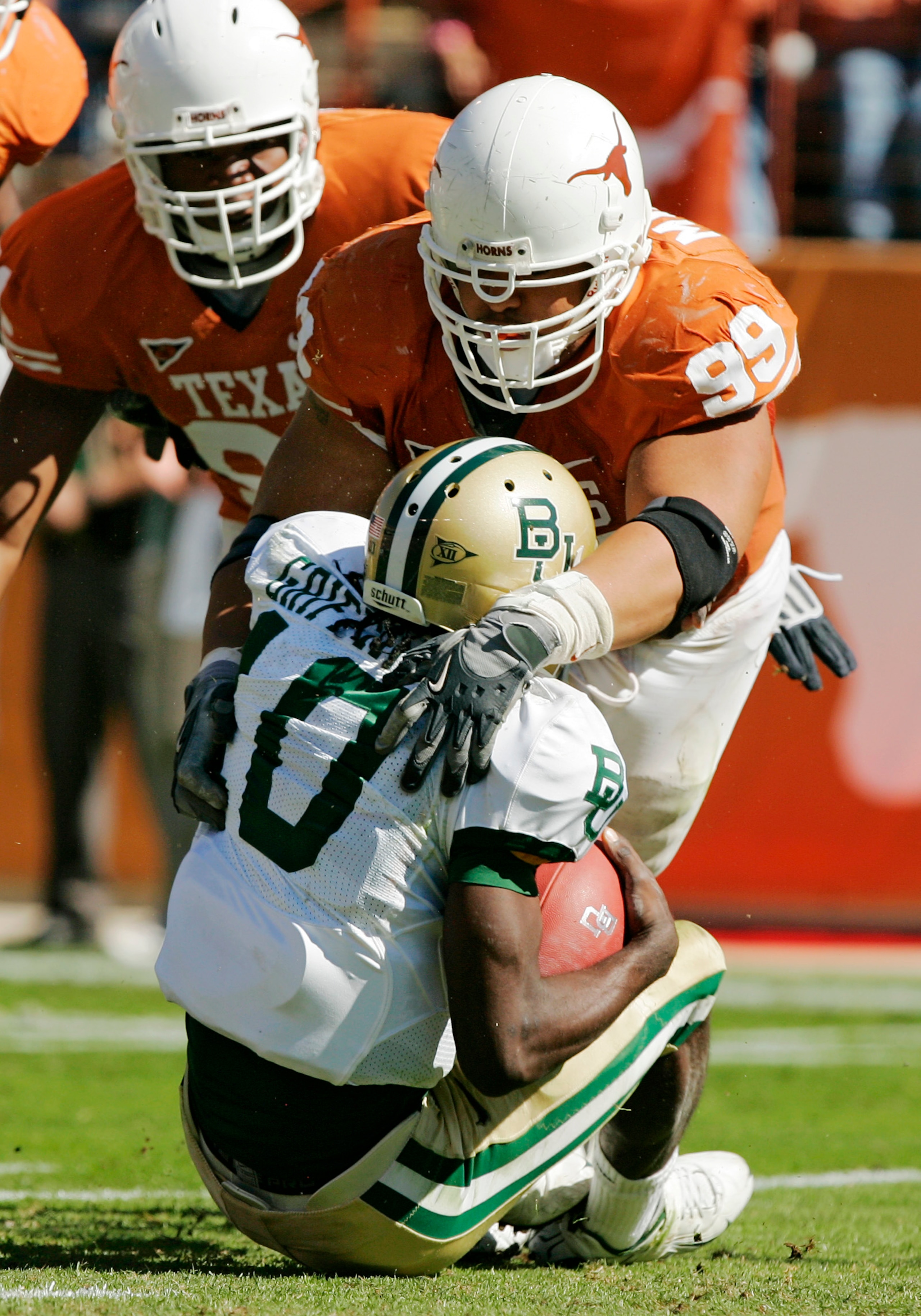 AUSTIN, TX - NOVEMBER 08:  Defensive tackle Roy Miller #99 of the Texas Longhorns sacks quarterback Robert Griffin #10 of the Baylor Bears in the second quarter on November 8, 2008 at Darrell K Royal-Texas Memorial Stadium in Austin, Texas.  (Photo by Bri