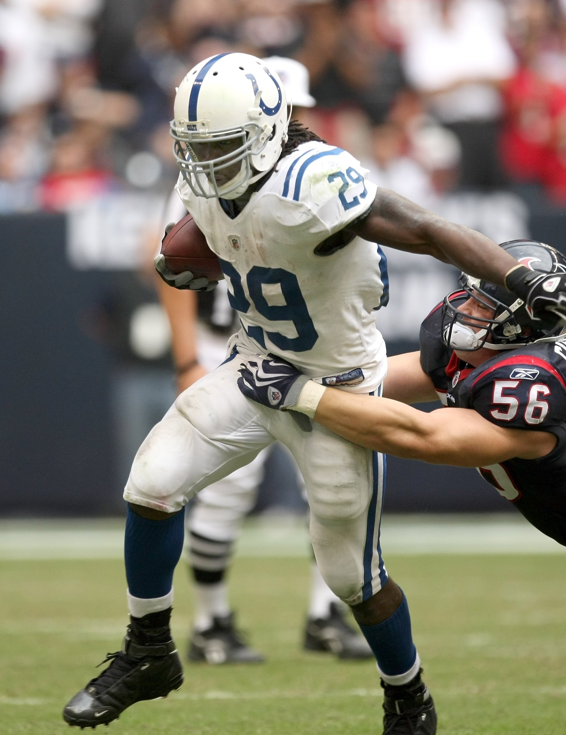 HOUSTON - NOVEMBER 29:  Running back Jospeh Addai #29 of the Indianapolis Colts rushes against linebacker Brian Cushing #56 of the Houston Texans on November 29, 2009  at Reliant Stadium in Houston, Texas. The Colts won 35-27.  (Photo by Stephen Dunn/Gett