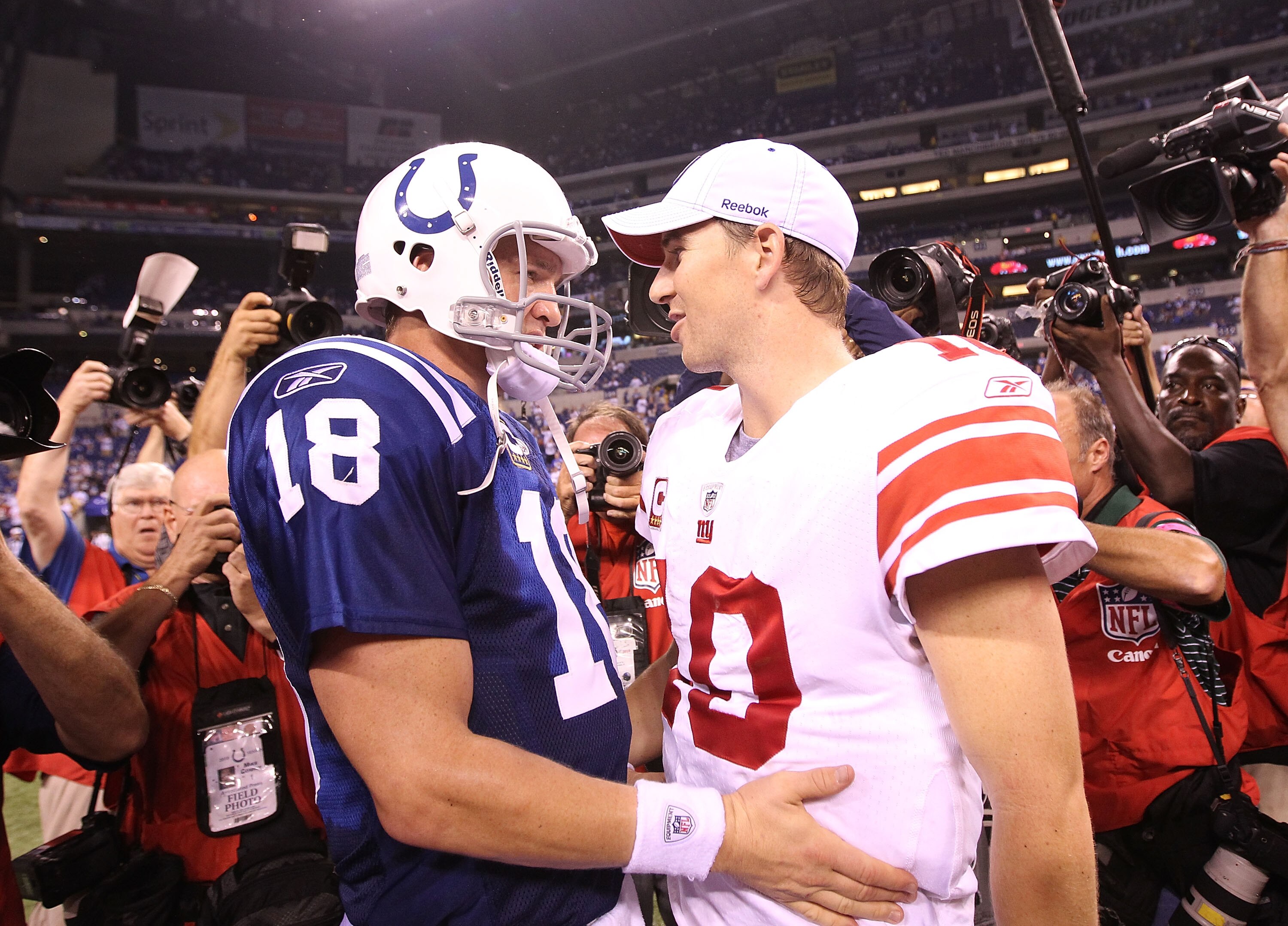 INDIANAPOLIS - SEPTEMBER 19:  Eli Manning #10 of the New York Giants and Peyton Manning #18 of the Indianapolis Colts embrace following the Colts 38-14 win at Lucas Oil Stadium on September 19, 2010 in Indianapolis, Indiana.  (Photo by Andy Lyons/Getty Im