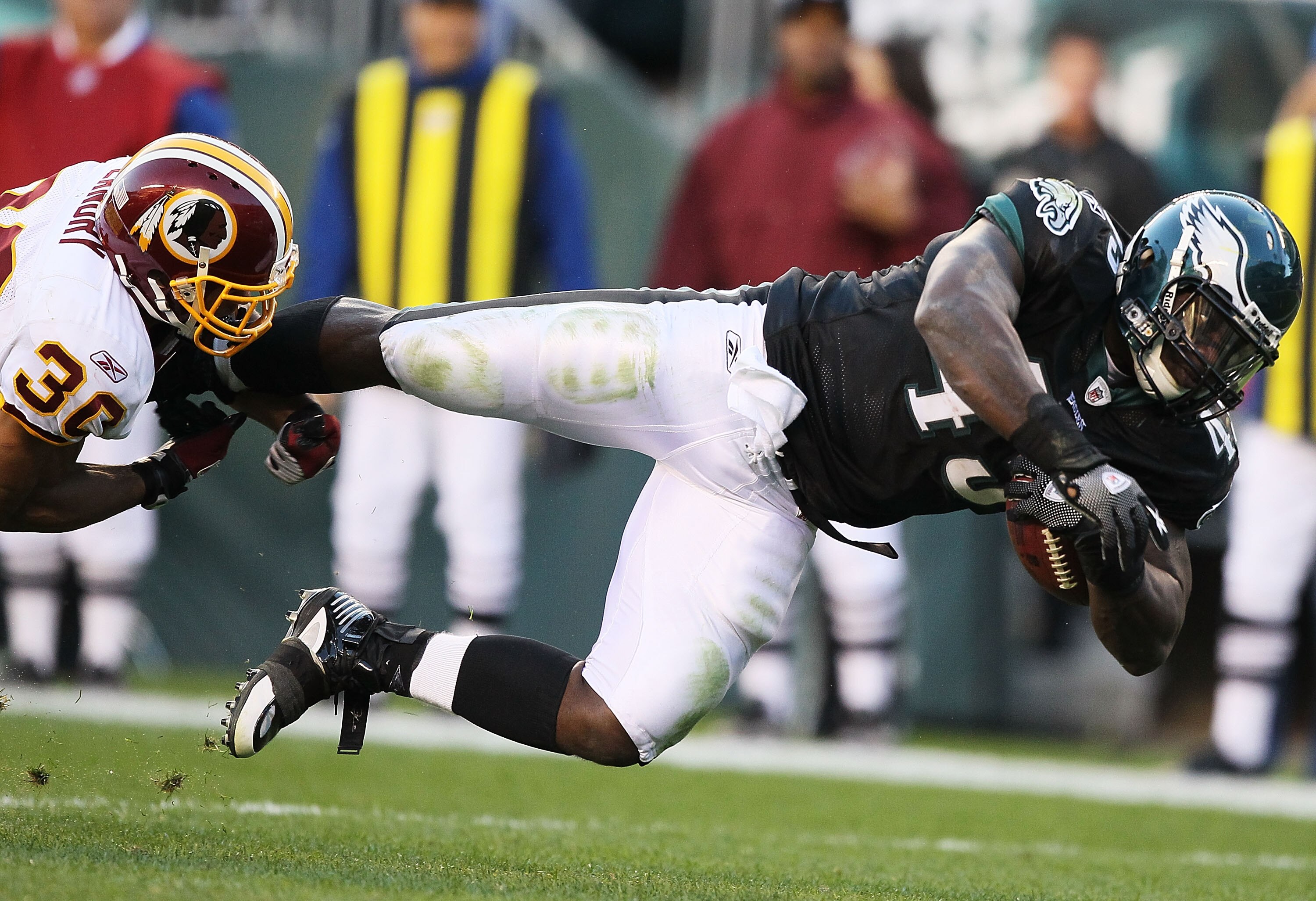 PHILADELPHIA - NOVEMBER 29:  Leonard Weaver #43 of the Philadelphia Eagles is tackled by LaRon Landry #30 of the Washington Redskins during their game at Lincoln Financial Field on November 29, 2009 in Philadelphia, Pennsylvania.  (Photo by Al Bello/Getty