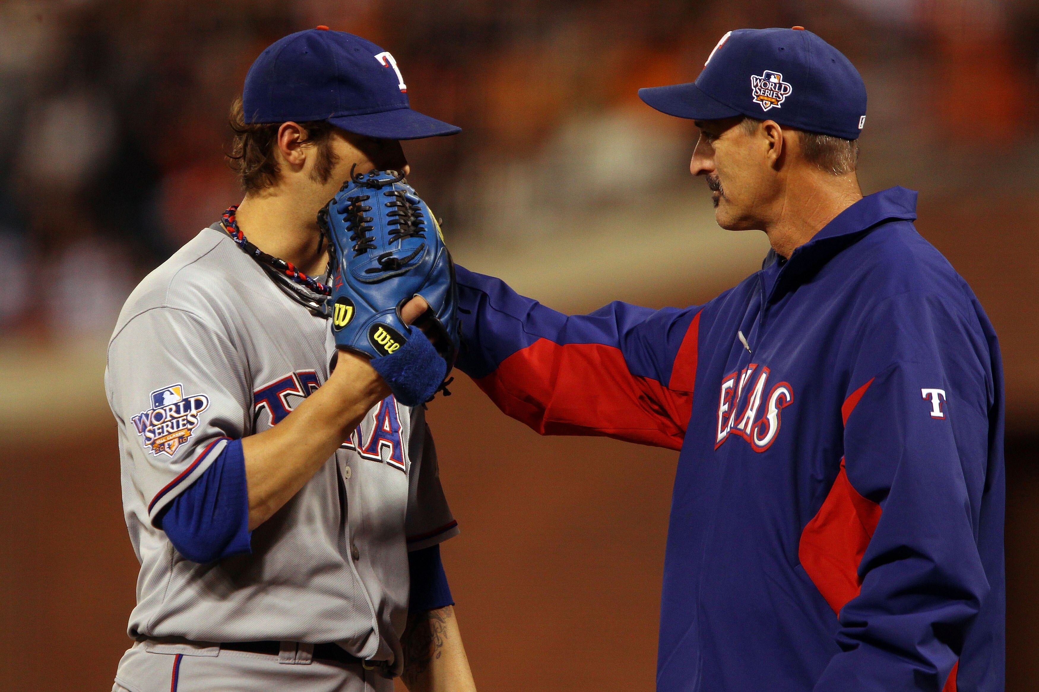 SAN FRANCISCO - OCTOBER 28:  C.J. Wilson #36 of the Texas Rangers has a meeting on the mound with pitching coach Mike Maddux in the seventh inning against the San Francisco Giants in Game Two of the 2010 MLB World Series at AT&T Park on October 28, 2010 i