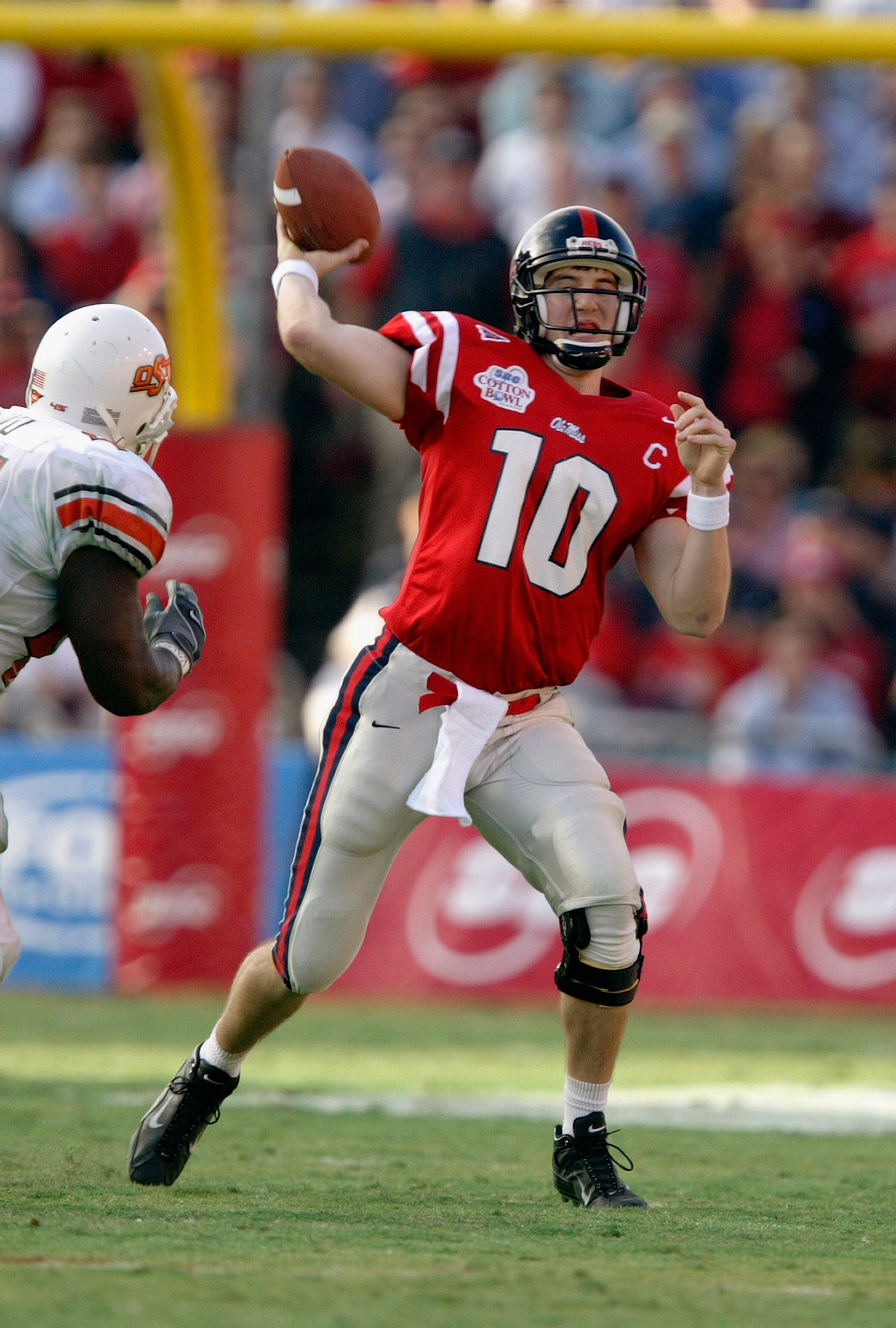 DALLAS - JANUARY 2:  Quarterback Eli Manning #10 of the Mississippi Rebels throws a pass against the Oklahoma State Cowboys during the SBC Cotton Bowl on January 2, 2004 at the Cotton Bowl in Dallas, Texas.  'Ole Miss defeated Oklahoma State 31-28.  (Phot