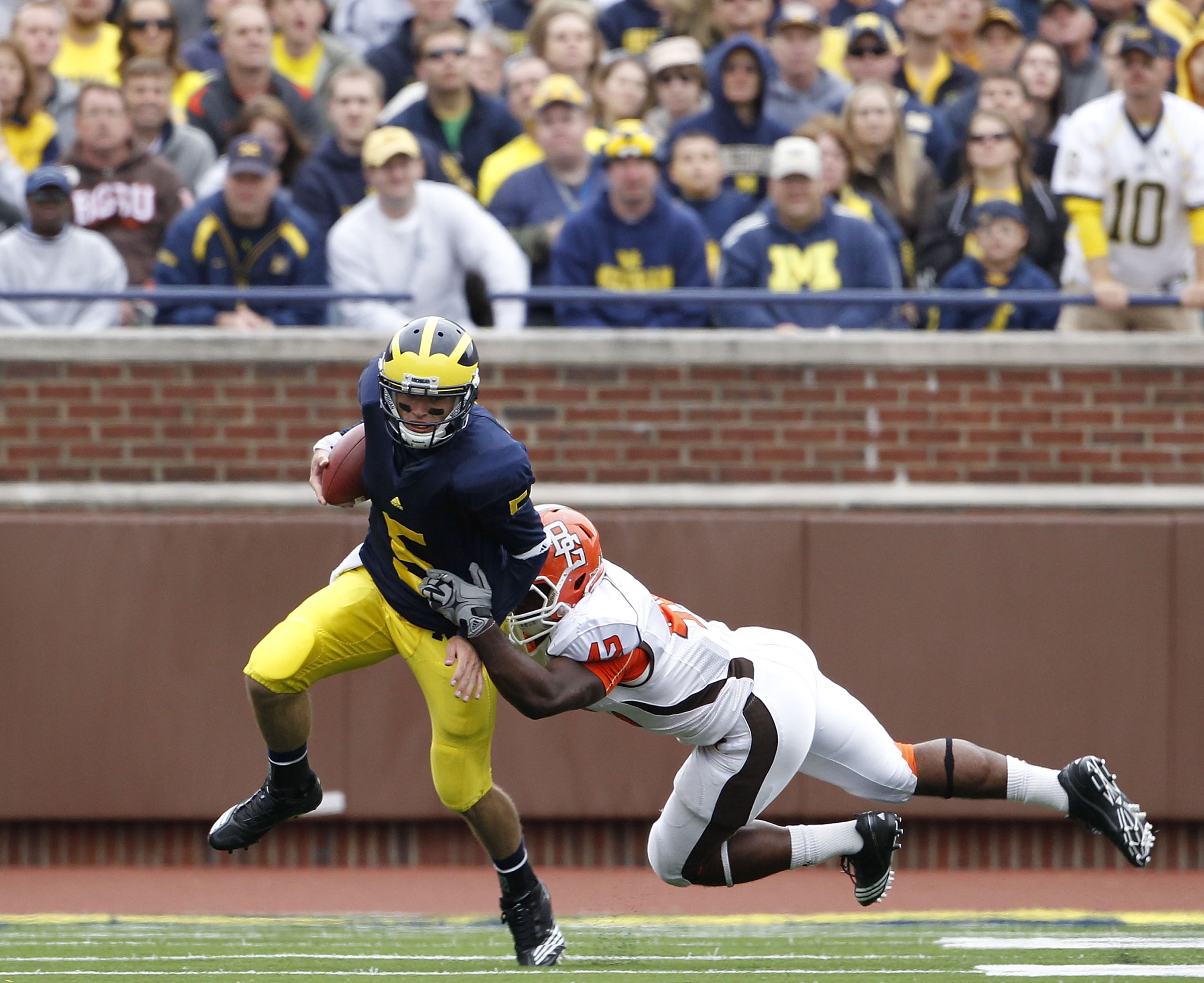 ANN ARBOR, MI - SEPTEMBER 25: Tate Forcier #5 of the Michigan Wolverines runs for a short gain as Eugene Fells #42 of Bowling Green makes the stop on September 25, 2010 at Michigan Stadium in Ann Arbor, Michigan. Michigan defeated Bowling Green 65-21.  (P