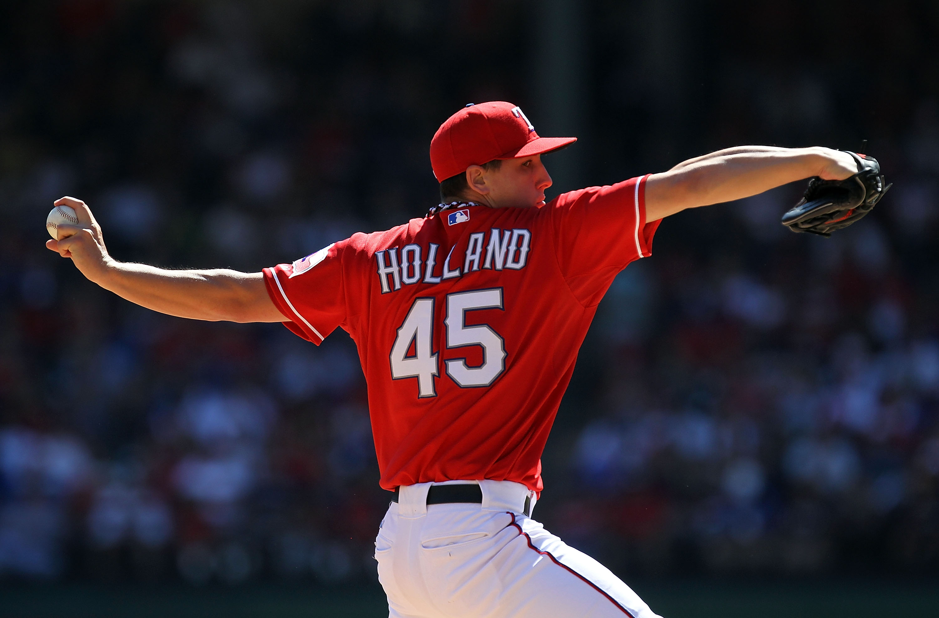 ARLINGTON, TX - OCTOBER 10:  Pitcher Derek Holland #45 of the Texas Rangers throws against the Tampa Bay Rays during game 4 of the ALDS at Rangers Ballpark in Arlington on October 10, 2010 in Arlington, Texas.  (Photo by Ronald Martinez/Getty Images)