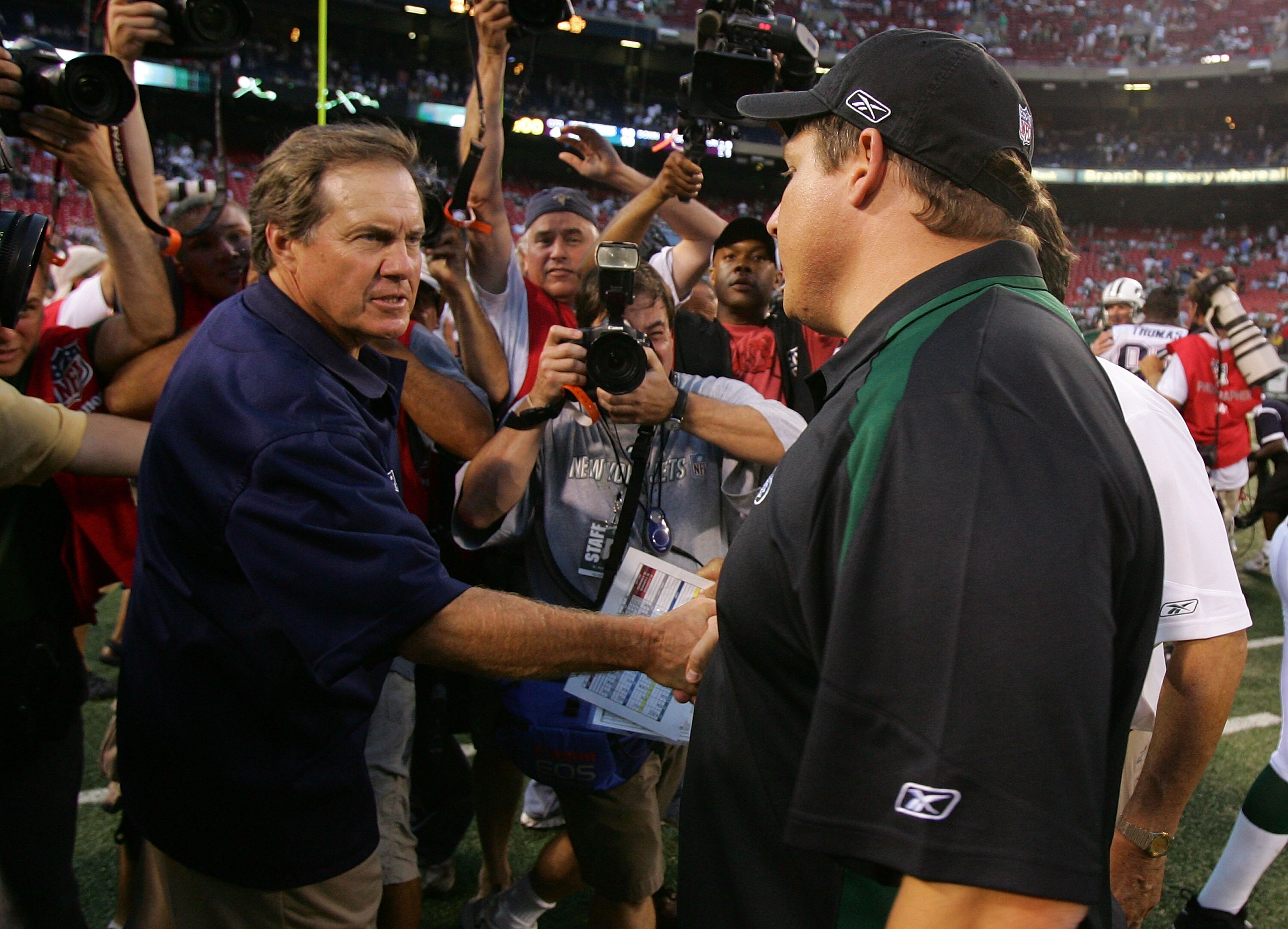 EAST RUTHERFORD, NJ - SEPTEMBER 14: Head coach Eric Mangini (R) of the New York Jets congratulates head coach Bill Belichick of the New England Patriots after their game on September 14, 2008 at Giants Stadium in East Rutherford, New Jersey. The Patriots EAST RUTHERFORD, NJ - SEPTEMBER 14: Head coach Eric Mangini (R) of the New York Jets congratulates head coach Bill Belichick of the New England Patriots after their game on September 14, 2008 at Giants Stadium in East Rutherford, New Jersey. The Patriots
