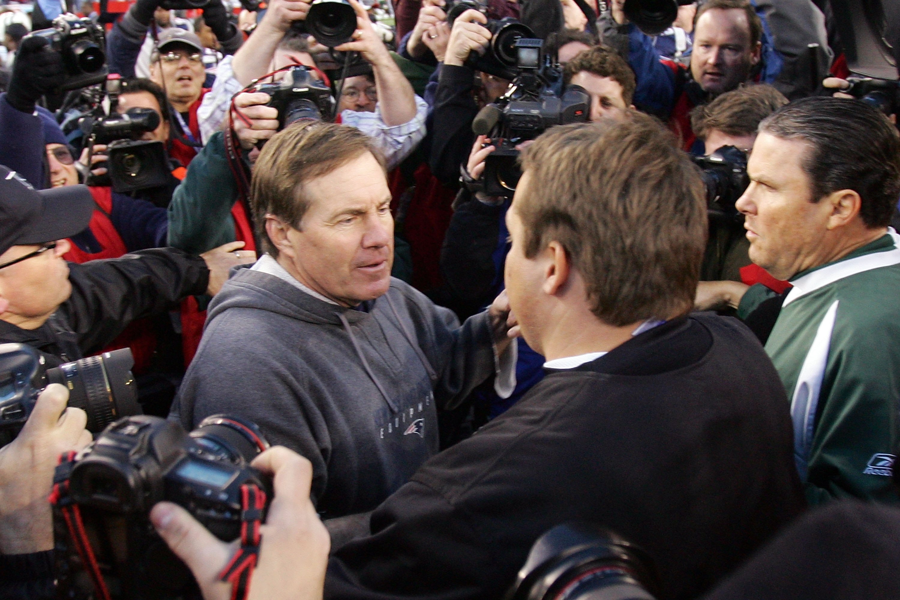 FOXBORO, MA - JANUARY 07: Head coach Eric Mangini of the New York Jets shakes hand with head coach Bill Belichick of the New England Patriots after their AFC Wild Card Playoff Game at Gillette Stadium on January 7, 2007 in Foxboro, Massachusetts. The Pa FOXBORO, MA - JANUARY 07: Head coach Eric Mangini of the New York Jets shakes hand with head coach Bill Belichick of the New England Patriots after their AFC Wild Card Playoff Game at Gillette Stadium on January 7, 2007 in Foxboro, Massachusetts. The Pa