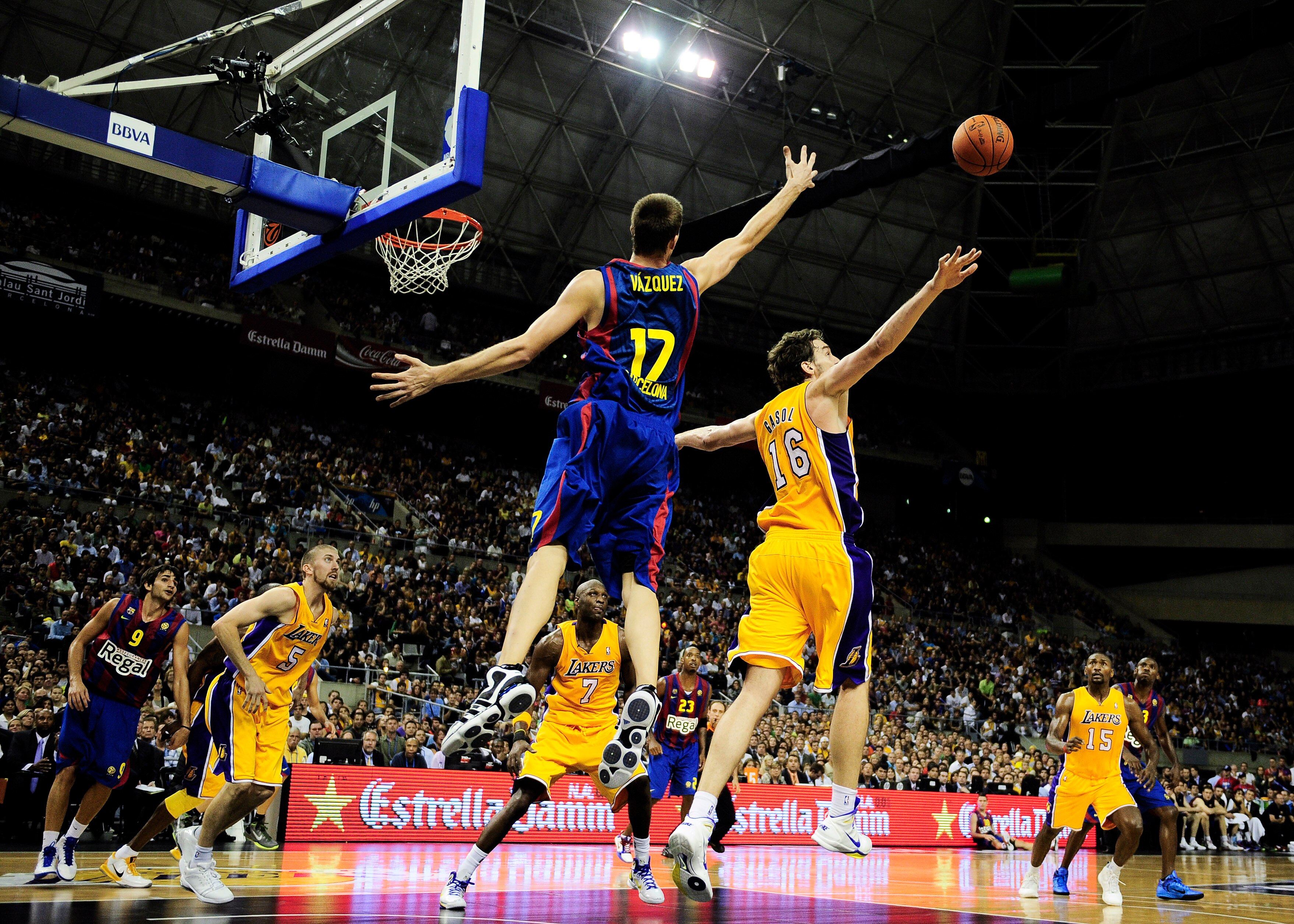 BARCELONA, SPAIN - OCTOBER 07:  Pau Gasol #16 of the Los Angeles Lakers streches to grab a rebound against Fran Vazquez #17 of the Regal FC Barcelona during the NBA Europe Live match between Los Angeles Lakers and Regal FC Barcelona at the at Palau Blaugr