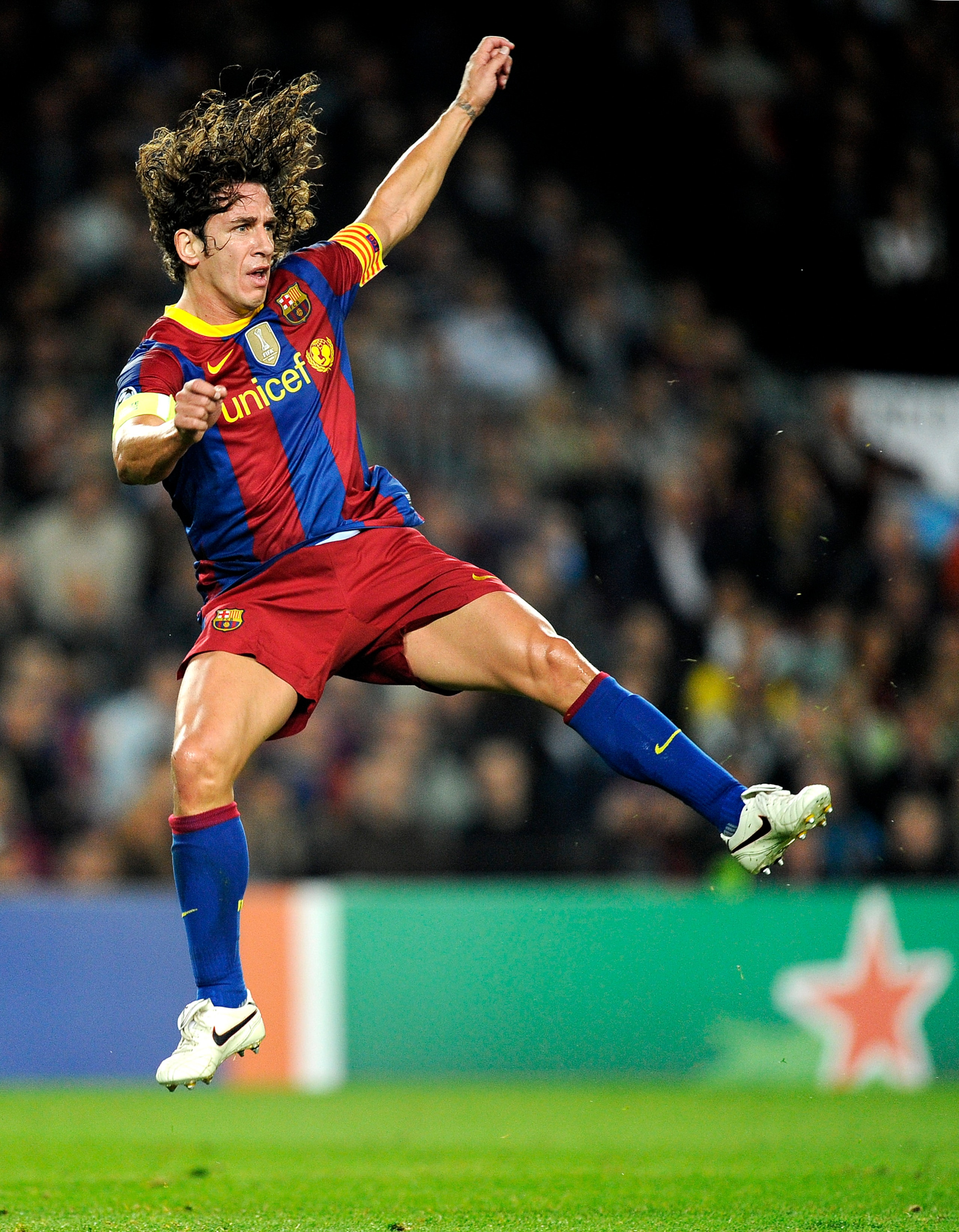 BARCELONA, SPAIN - OCTOBER 20:  Carles Puyol of Barcelona jumps after kicking the ball during the UEFA Champions League group D match between Barcelona and FC Copenhagen at the Camp nou stadium on October 20, 2010 in Barcelona, Spain. Barcelona won the ma