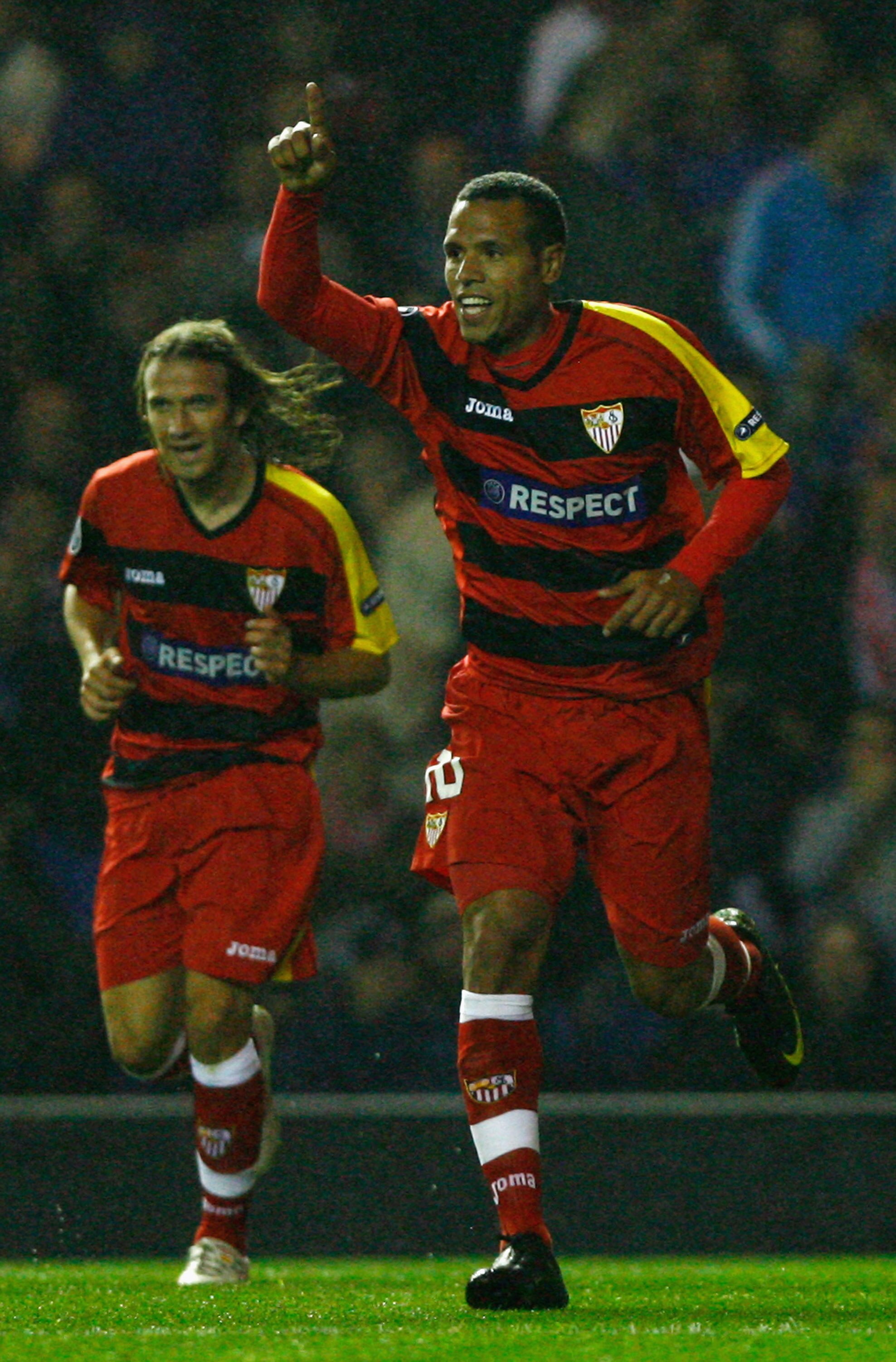 GLASGOW, SCOTLAND - SEPTEMBER 29:  Luis Fabiano (R) of Sevilla celebrates during the UEFA Champions League Group G match between Rangers and Sevilla at Ibrox Stadium on September 29, 2009 in Glasgow, Scotland.  (Photo by Jeff J Mitchell/Getty Images)