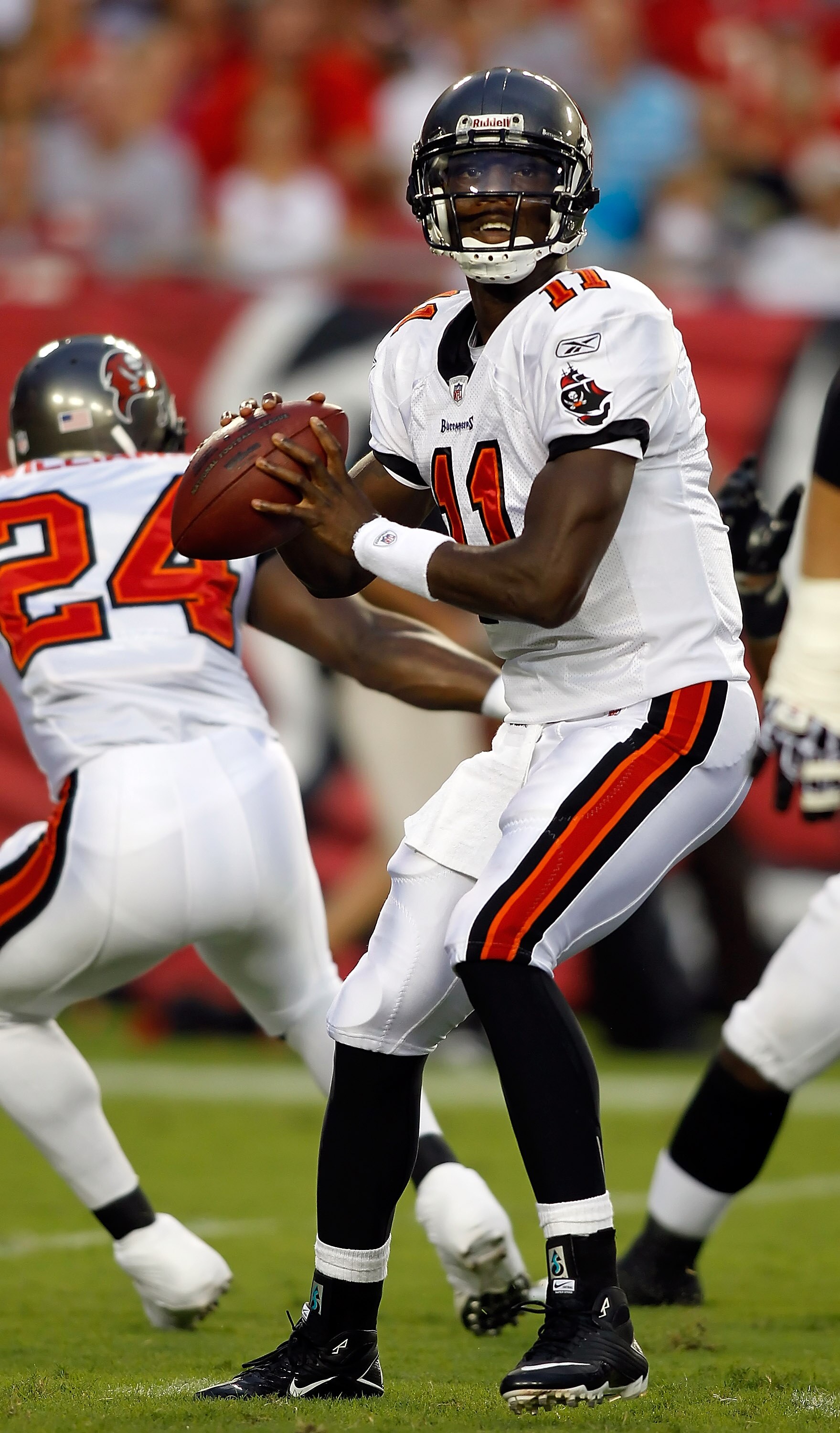 TAMPA, FL - AUGUST 28:  Quarterback Josh Johnson #11 of the Tampa Bay Buccaneers looks for an open receiver against the Jacksonville Jaguars during a preseason game at Raymond James Stadium on August 28, 2010 in Tampa, Florida.  (Photo by J. Meric/Getty I