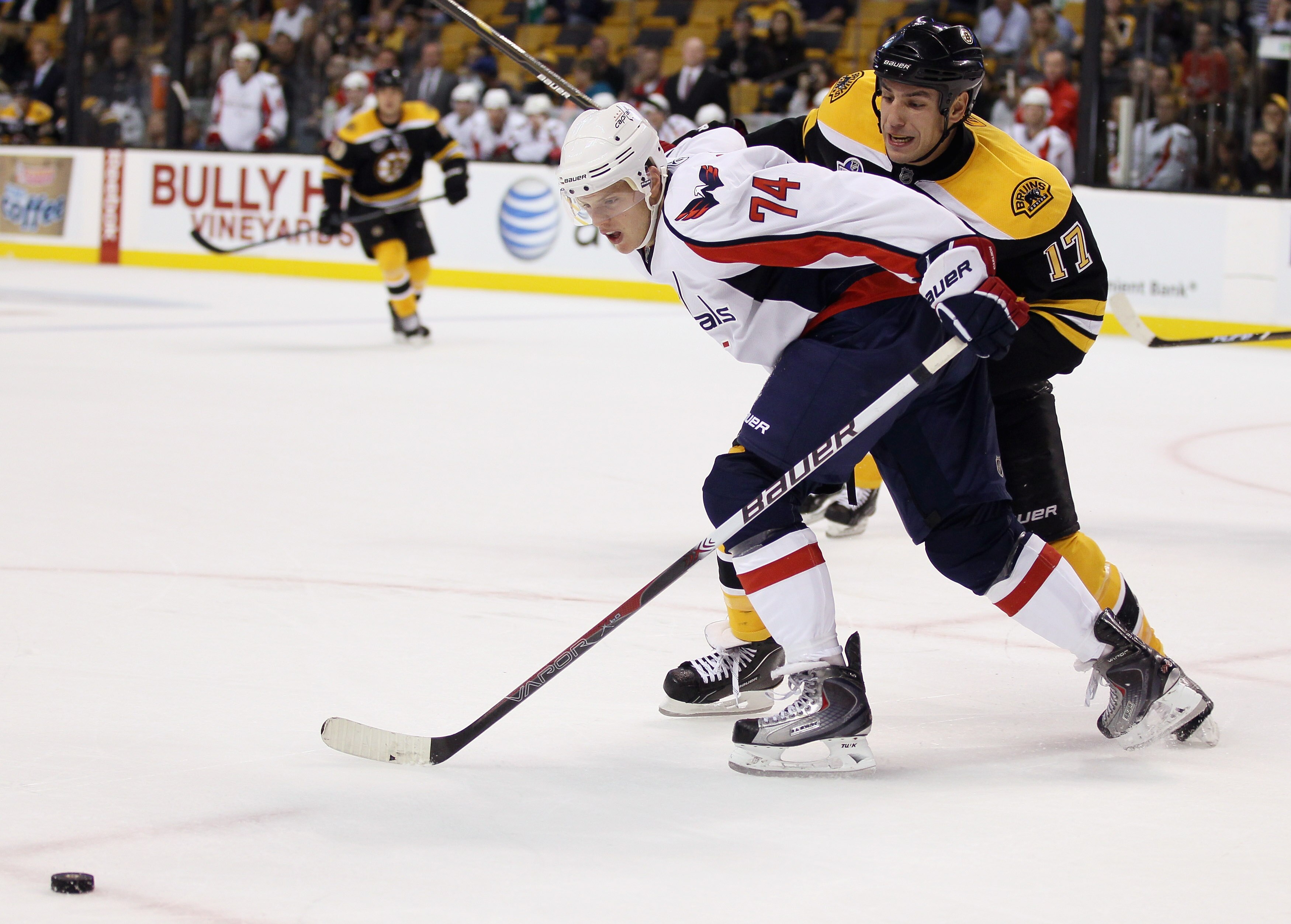 BOSTON - SEPTEMBER 29: Milan Lucic #17 of the Boston Bruins and John Carlson #74 of the Washington Capitals fight for the puck on September 29, 2010 at the TD Garden in Boston, Massachusetts. The Capitals defeated the Bruins 4-1.  (Photo by Elsa/Getty Ima