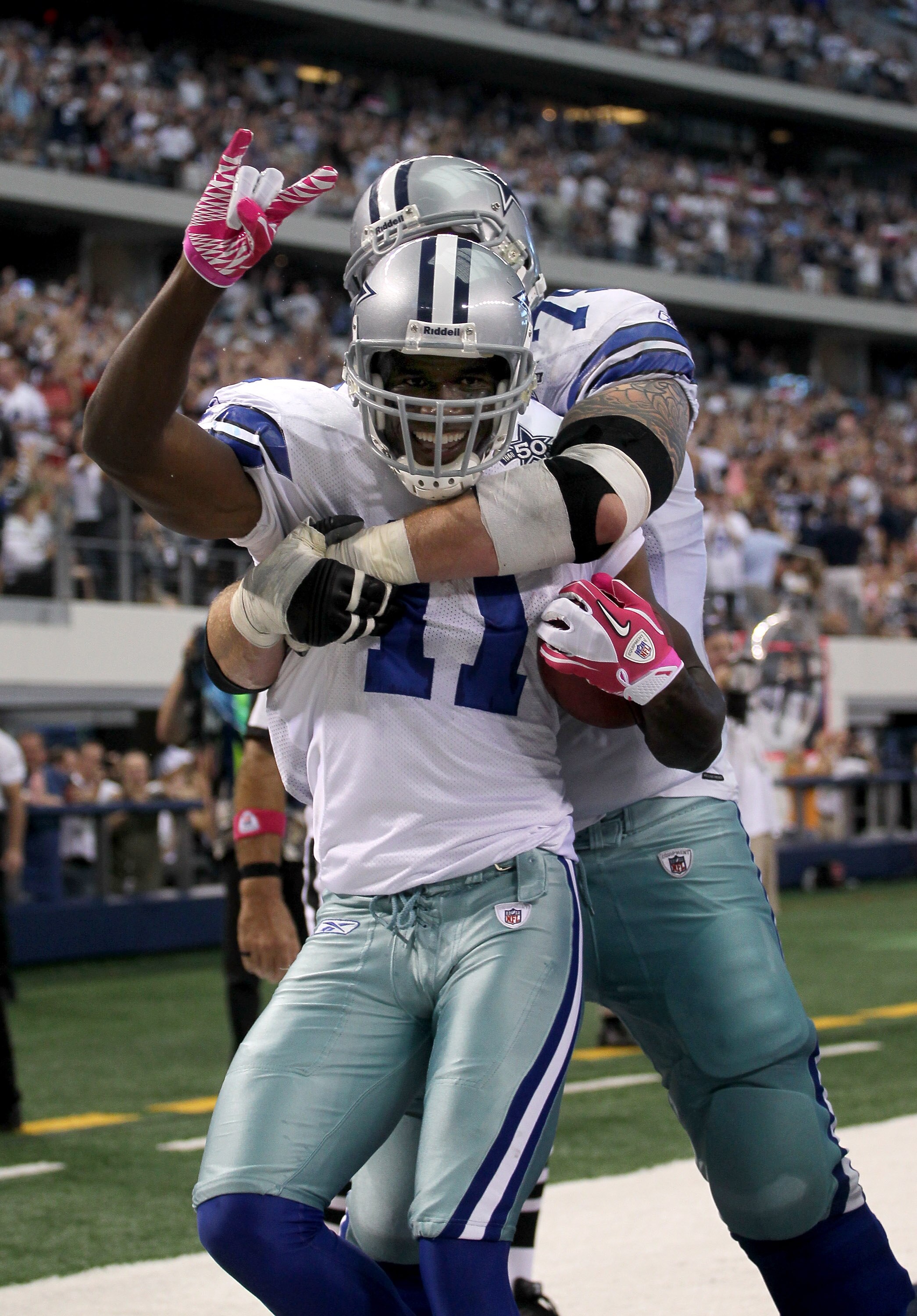 ARLINGTON, TX - OCTOBER 10: Wide receiver Roy Williams #11 of the Dallas Cowboys is hugged by tackle Marc Colombo #75 after making a six yard touchdown reception in the second quarter against the Tennessee Titans at Cowboys Stadium on October 10, 2010 in