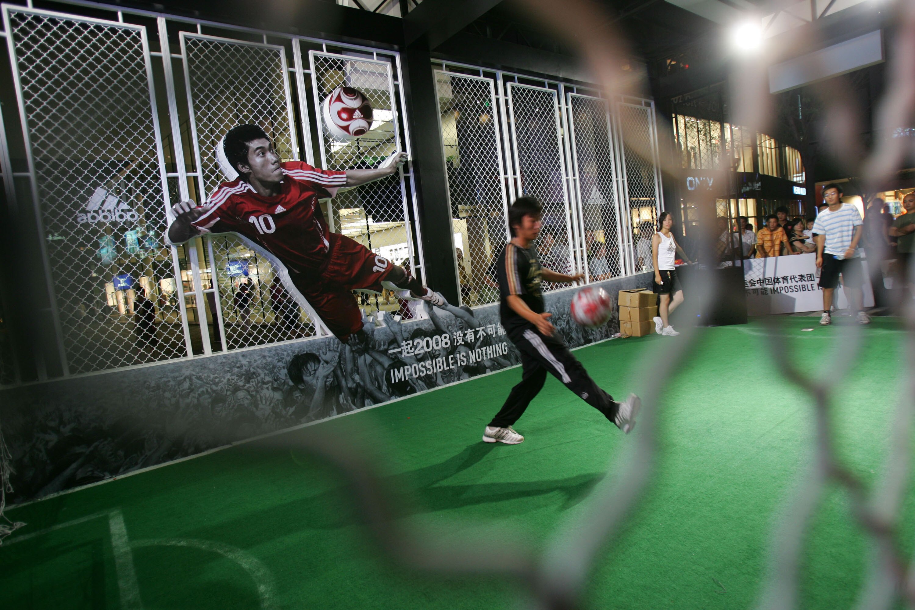 BEIJING, CHINA - AUGUST 13: (CHINA OUT) Residents play football games to win Olympic Games tickets during a competition held in an Adidas flagship store August 13, 2008 in Beijing, China. The Beijing Olympic Games entered its fifth day on August 13. (Phot