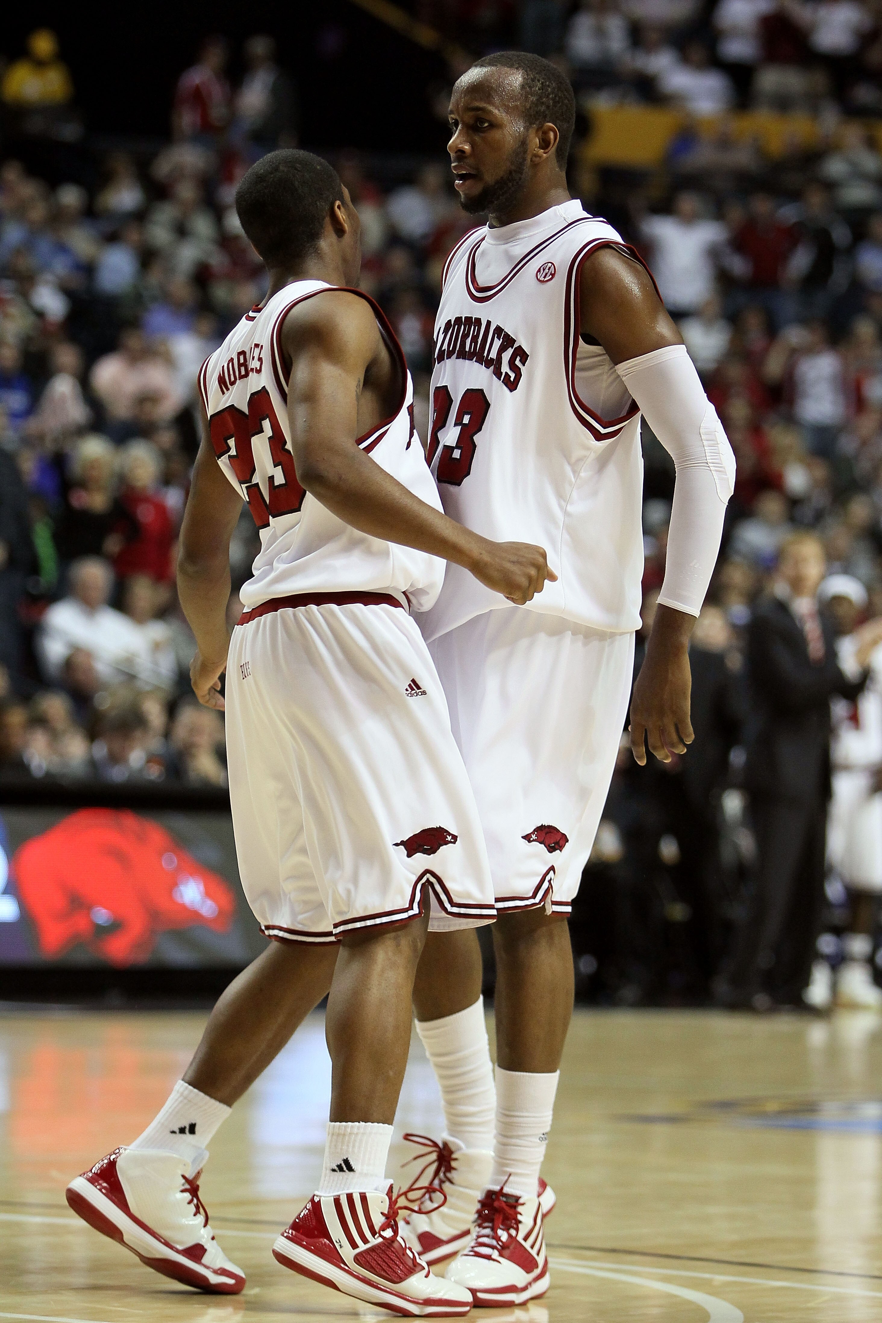 NASHVILLE, TN - MARCH 11:  (L-R) Julysses Nobles #23 and Marshawn Powell #33 of the Arkanasas Razorbacks react to a play against the Georgia Bulldogs during the first round of the SEC Men's Basketball Tournament at the Bridgestone Arena on March 11, 2010