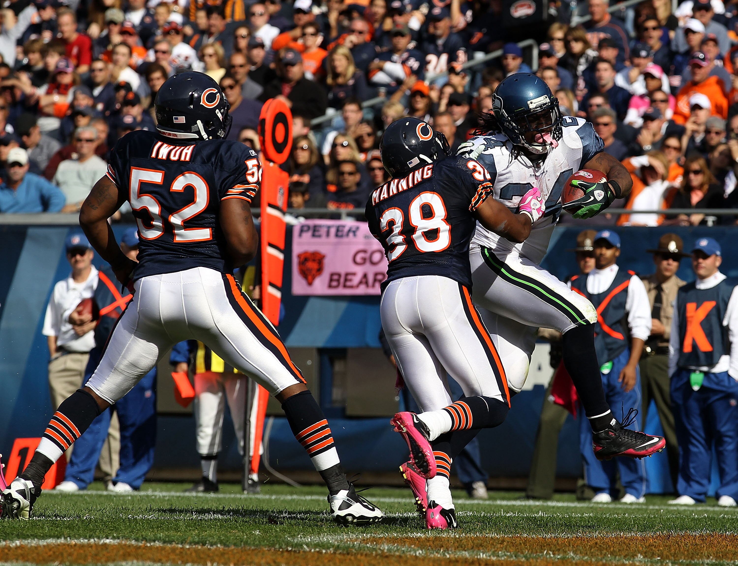 CHICAGO - OCTOBER 17: Marshawn Lynch #24 of the Seattle Seahawks scores a touchdown pursued by Brian Iwuh #52 and Danieal Manning #38 of the Chicago Bears at Soldier Field on October 17, 2010 in Chicago, Illinois. The Seahawks defeated the Bears 23-20. (P