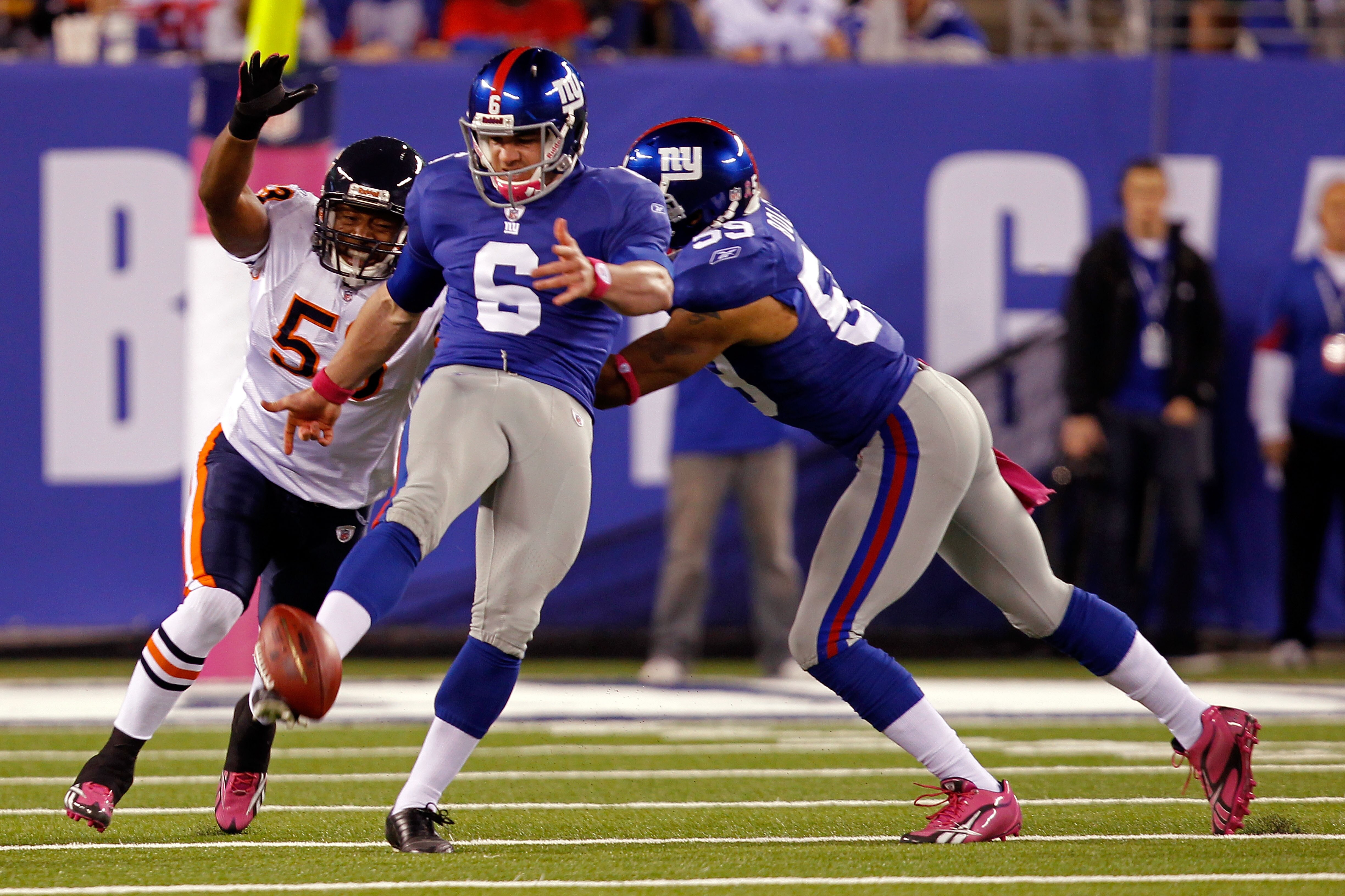 EAST RUTHERFORD, NJ - OCTOBER 03:  Matt Dodge #6 of the New York Giants punts the after bobbling the snap against Nick Roach #53 of the Chicago Bears at New Meadowlands Stadium on October 3, 2010 in East Rutherford, New Jersey.  (Photo by Michael Heiman/G