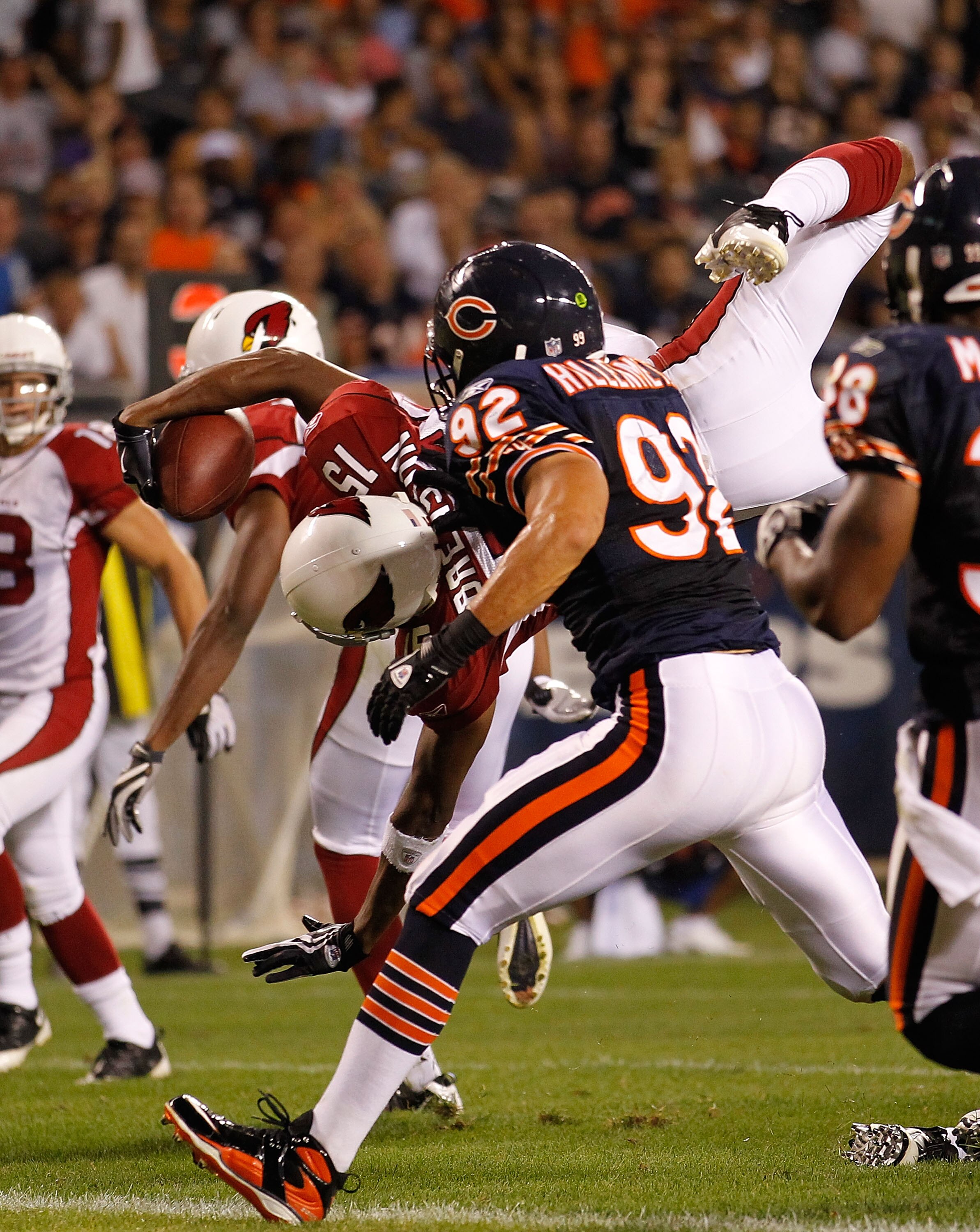 CHICAGO - AUGUST 28: Steve Breaston #15 of the Arizona Cardinals dives in to the end zone for a touchdown as Hunter Hillenmeyer #92 of the Chicago Bears pursues during a preseason game at Soldier Field on August 28, 2010 in Chicago, Illinois. The Cardinal