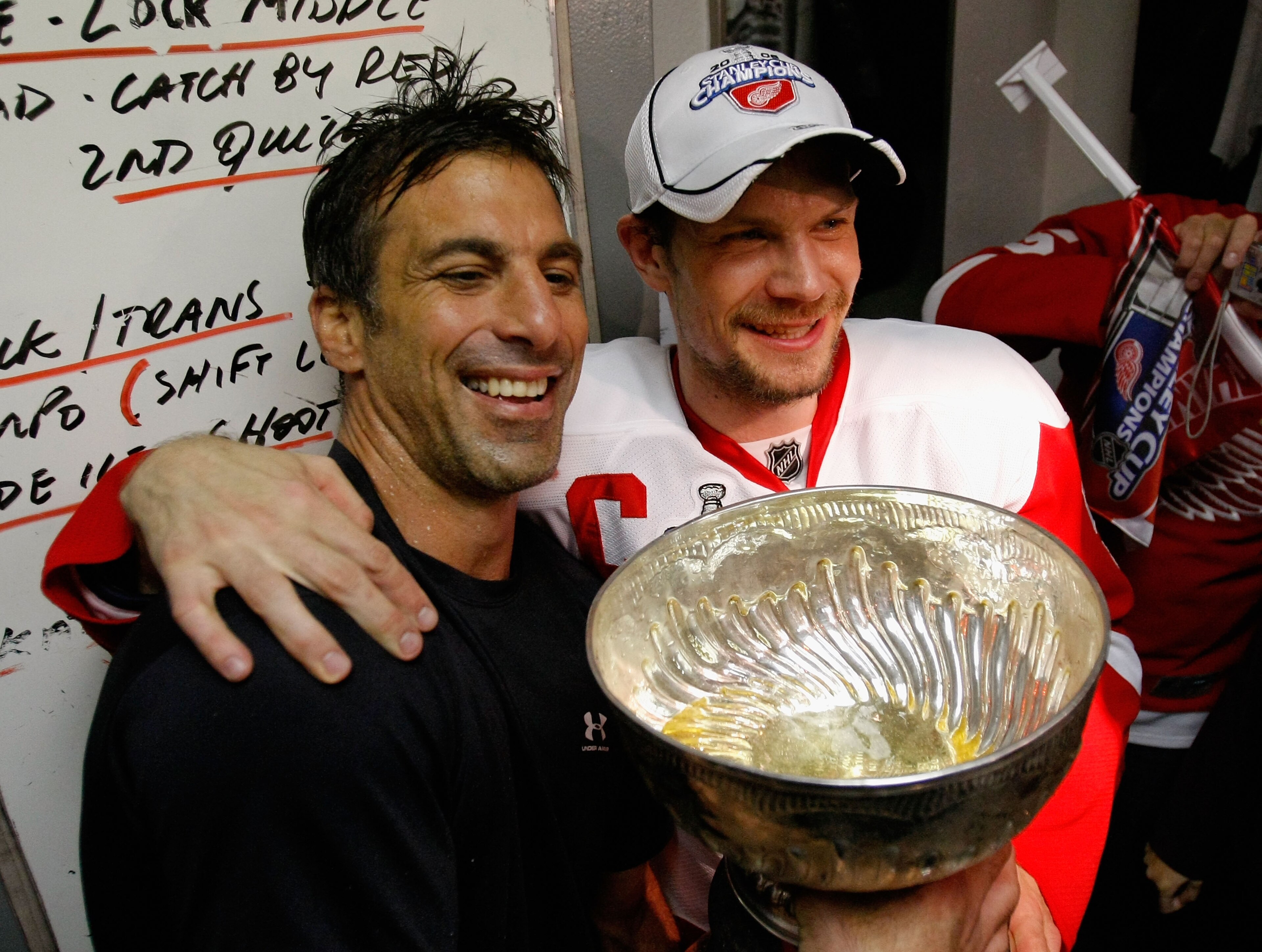 PITTSBURGH - JUNE 04: Chris Chelios and Nicklas Lidstrom of the Detroit Red Wings celebrate with the Stanley Cup in the locker room after defeating the Pittsburgh Penguins in game six of the 2008 NHL Stanley Cup Finals at Mellon Arena on June 4, 2008 in PITTSBURGH - JUNE 04: Chris Chelios and Nicklas Lidstrom of the Detroit Red Wings celebrate with the Stanley Cup in the locker room after defeating the Pittsburgh Penguins in game six of the 2008 NHL Stanley Cup Finals at Mellon Arena on June 4, 2008 in