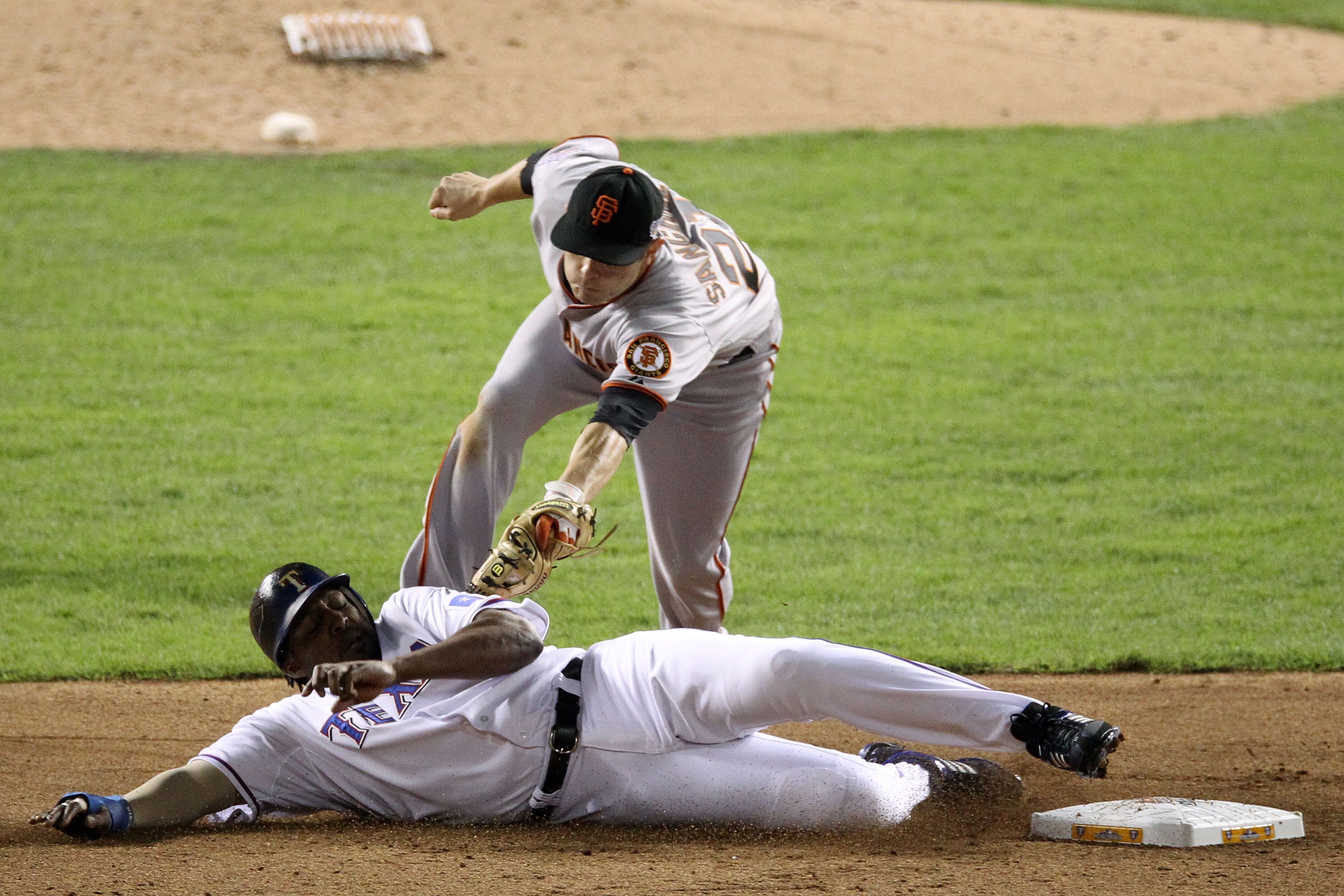 ARLINGTON, TX - OCTOBER 30:  Vladimir Guerrero #27 of the Texas Rangers is tagged out on a steal attempt by Freddy Sanchez #21 against the San Francisco Giants in the bottom of the fifth inning of Game Three of the 2010 MLB World Series at Rangers Ballpar