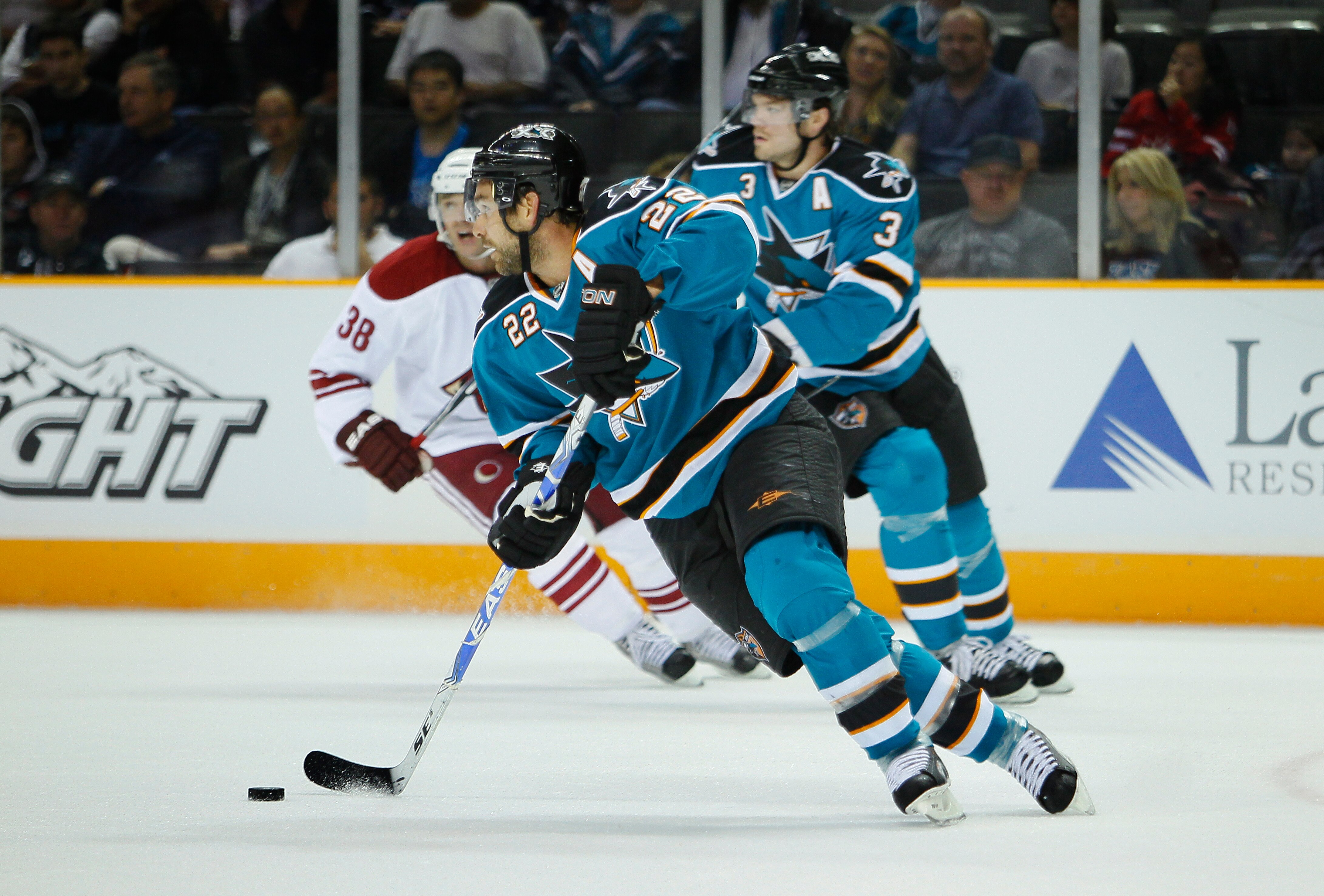 SAN JOSE, CA - SEPTEMBER 25:  Dan Boyle #22 of the San Jose Sharks turns with the puck against the Phoenix Coyotes against the San Jose Sharks in a preseason split-squad game at HP Pavilion on September 25, 2010 in San Jose, California.  The Sharks won 3-