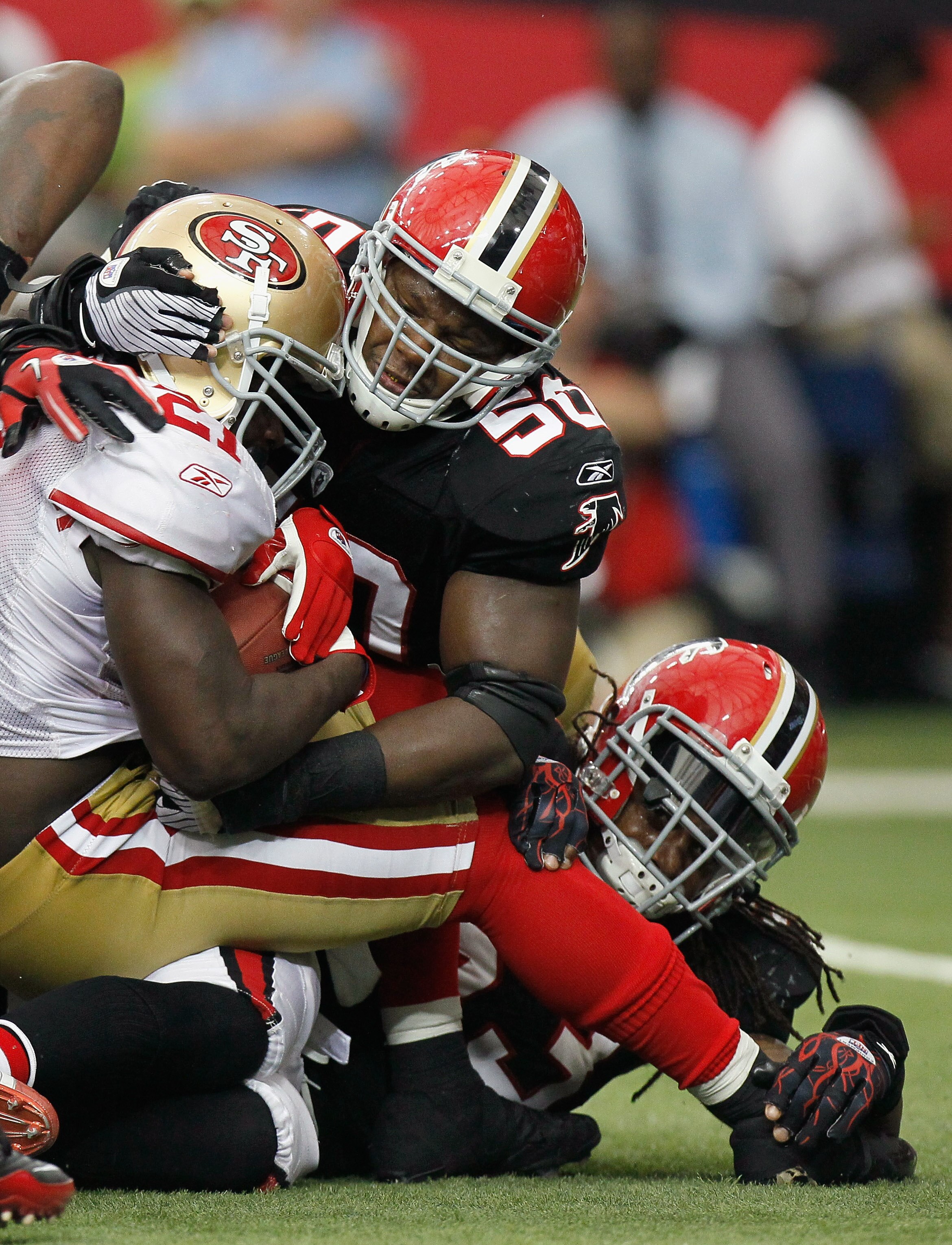 ATLANTA - OCTOBER 03:  Mike Peterson #53 and Curtis Lofton #50 of the Atlanta Falcons tackles Frank Gore #21 of the San Francisco 49ers at Georgia Dome on October 3, 2010 in Atlanta, Georgia.  (Photo by Kevin C. Cox/Getty Images)
