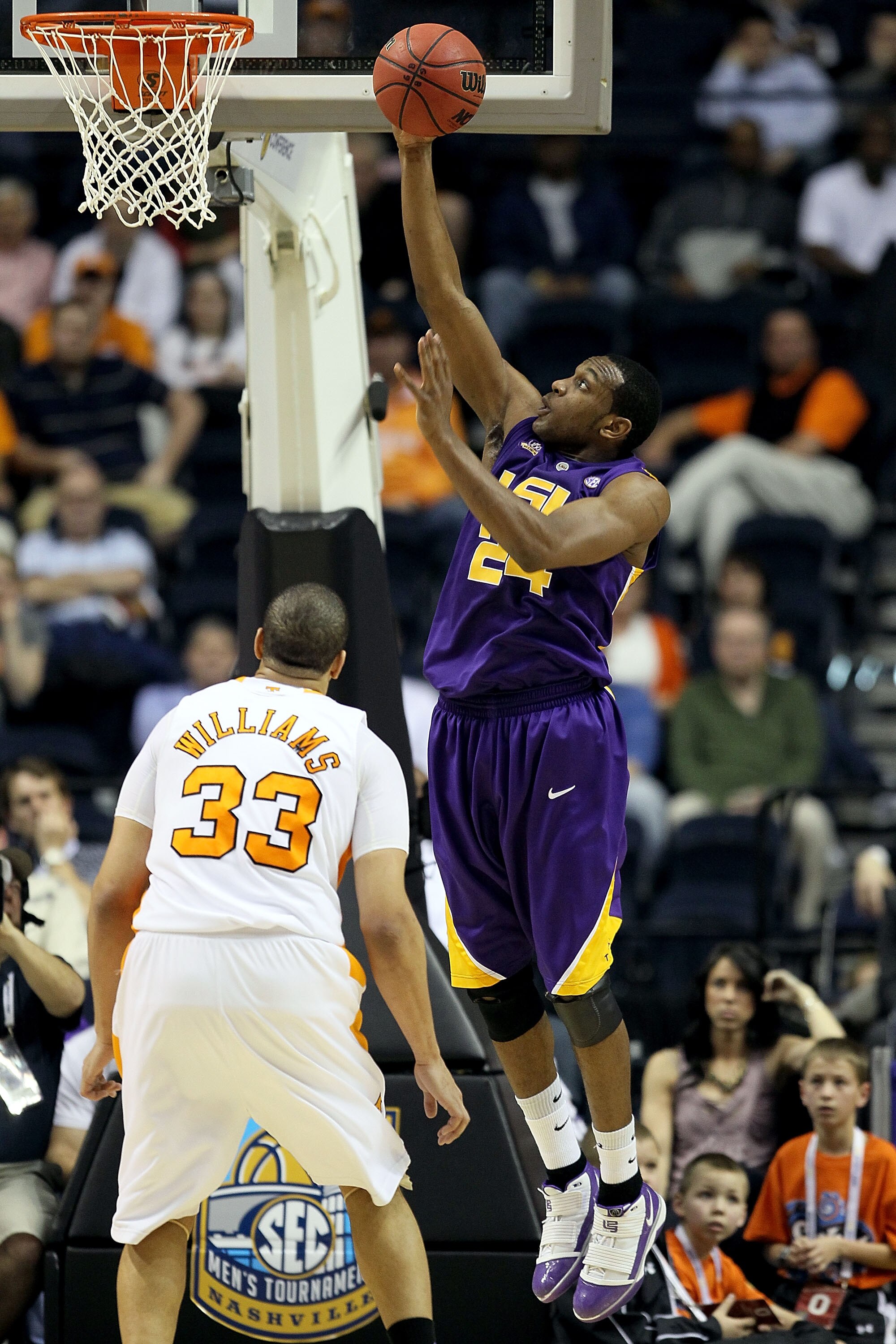 NASHVILLE, TN - MARCH 11:  Storm Warren #24 of the LSU Tigers drives for a shot attempt against Brian Williams #33 of the Tennessee Volunteers during the first round of the SEC Men's Basketball Tournament at the Bridgestone Arena on March 11, 2010 in Nash