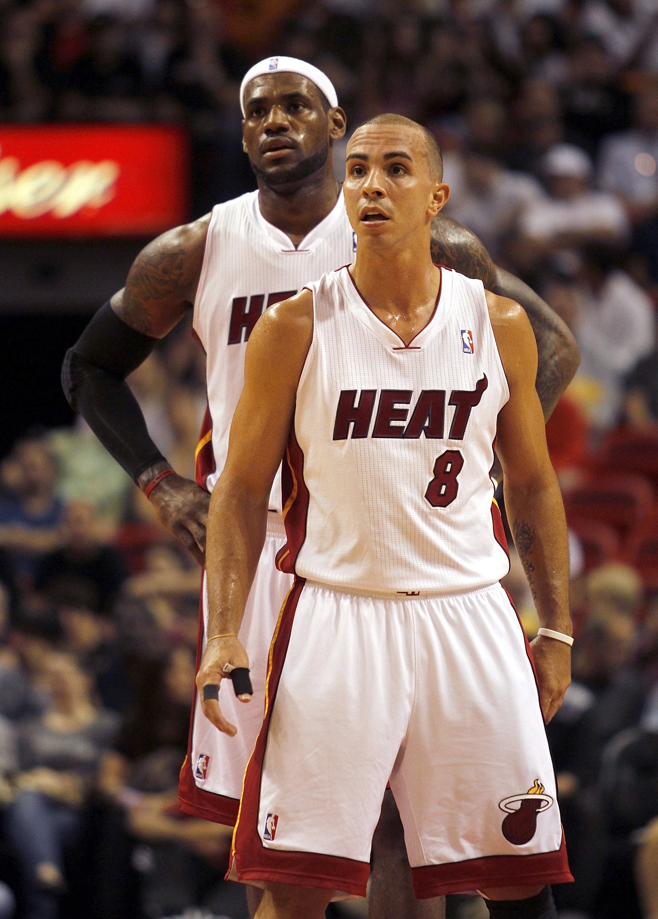 MIAMI - OCTOBER 18:  Forward LeBron James #6 and Carlos Arroyo #8 of the Miami Heat look on while playing against the Charlotte Bobcats on October 18, 2010 at American Airlines Arena in Miami, Florida. NOTE TO USER: User expressly acknowledges and agrees 