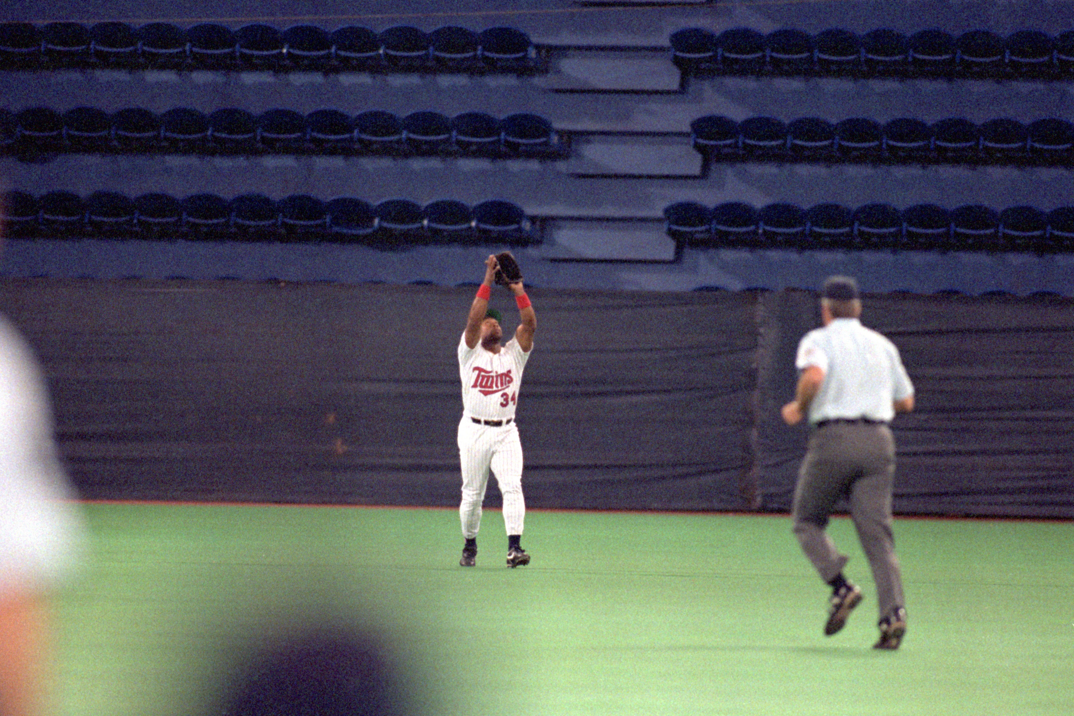 MINNEAPOLIS - OCTOBER 20:  Kirby Puckett #34 of the Minnesota Twins reaches for a pop fly during Game two of the 1991 World Series against the Atlanta Braves at the Metrodome on October 20, 1991 in Minneapolis, Minnesota. The Twins defeated the Braves 3-2