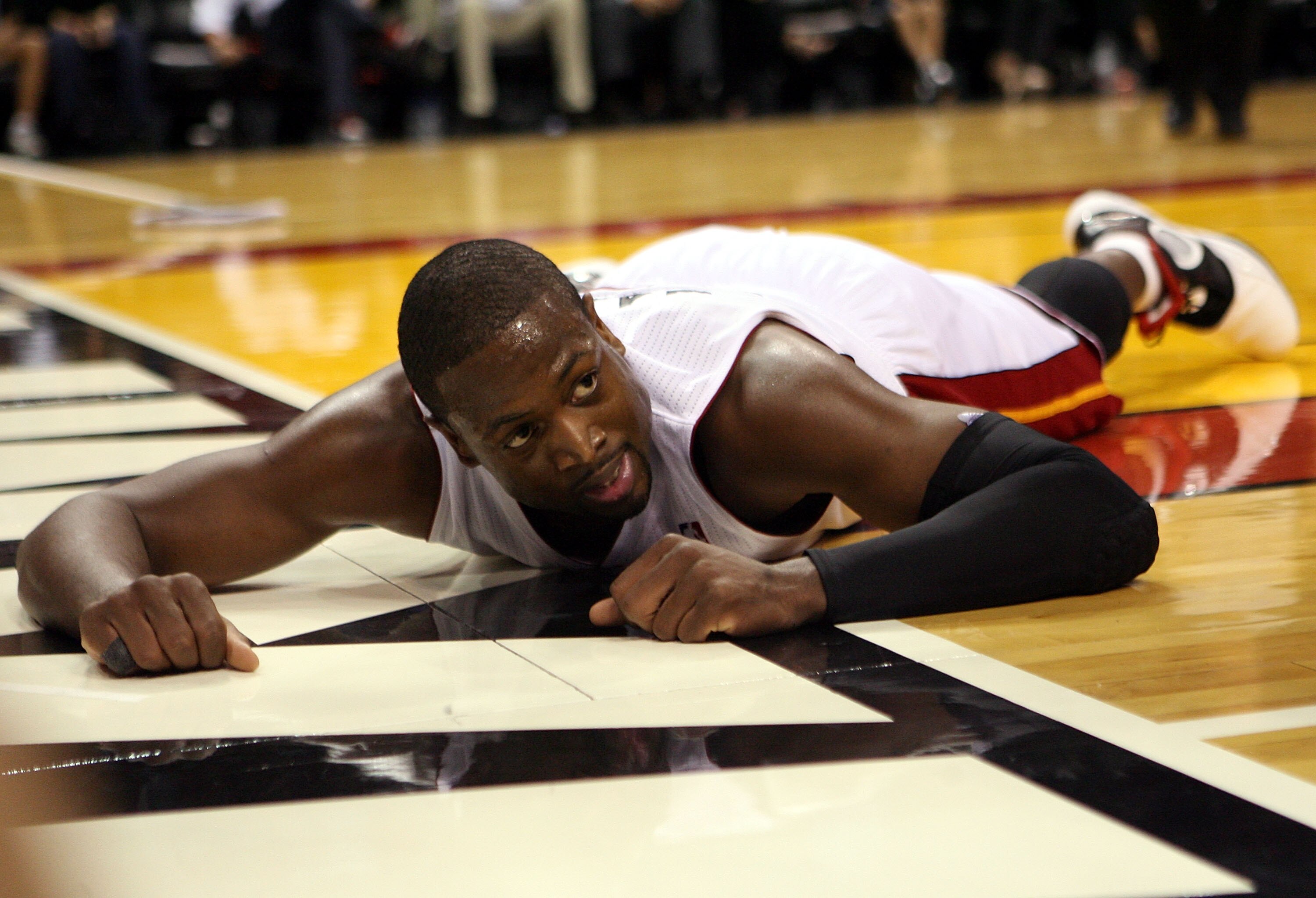 MIAMI - OCTOBER 29:  Guard Dwyane Wade #3 of  the Miami Heatlays on the floor against the Orlando Magic at American Airlines Arena on October 29, 2010 in Miami, Florida.  NOTE TO USER: User expressly acknowledges and agrees that, by downloading and or usi