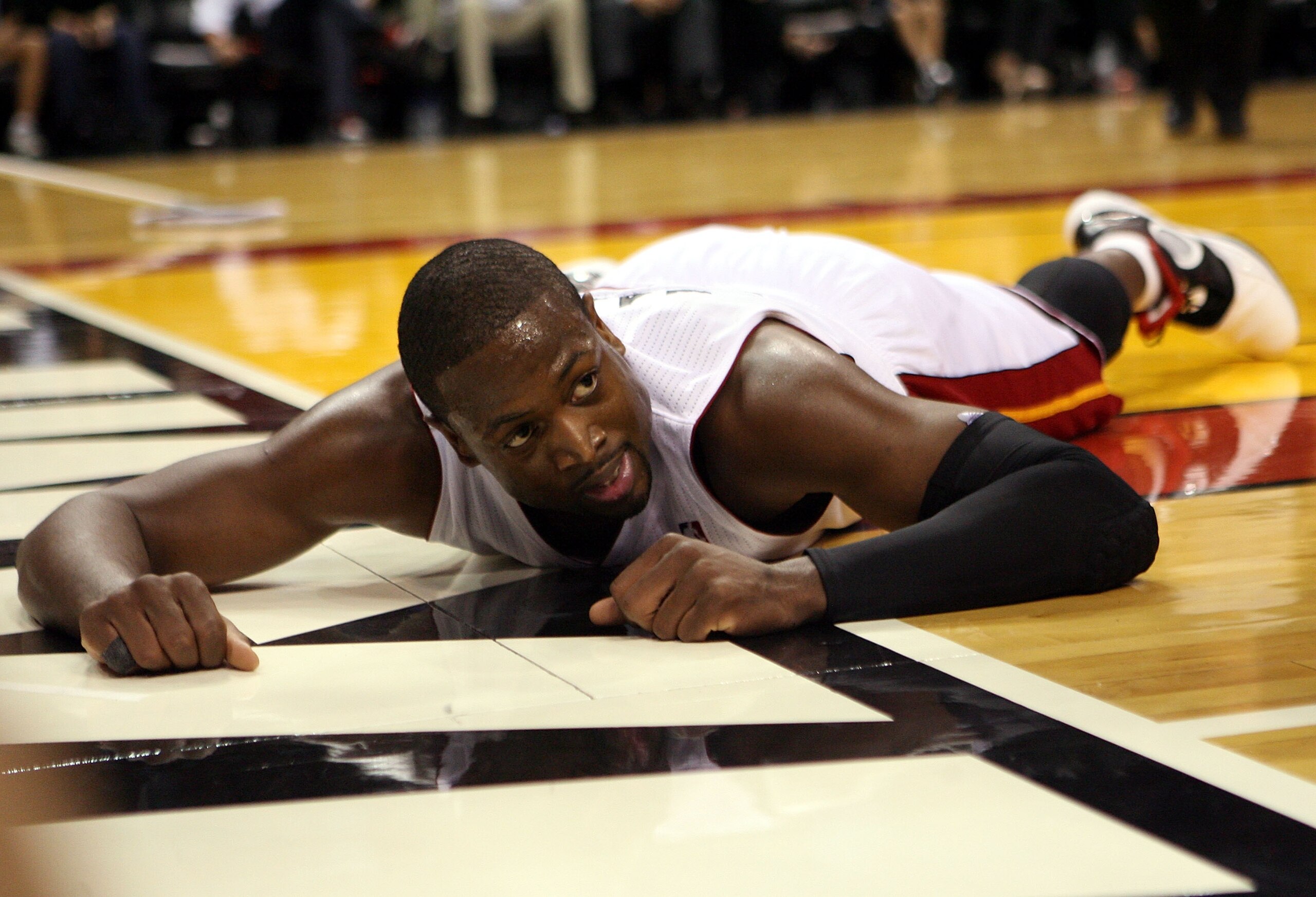 MIAMI - OCTOBER 29:  Guard Dwyane Wade #3 of  the Miami Heatlays on the floor against the Orlando Magic at American Airlines Arena on October 29, 2010 in Miami, Florida.  NOTE TO USER: User expressly acknowledges and agrees that, by downloading and or usi