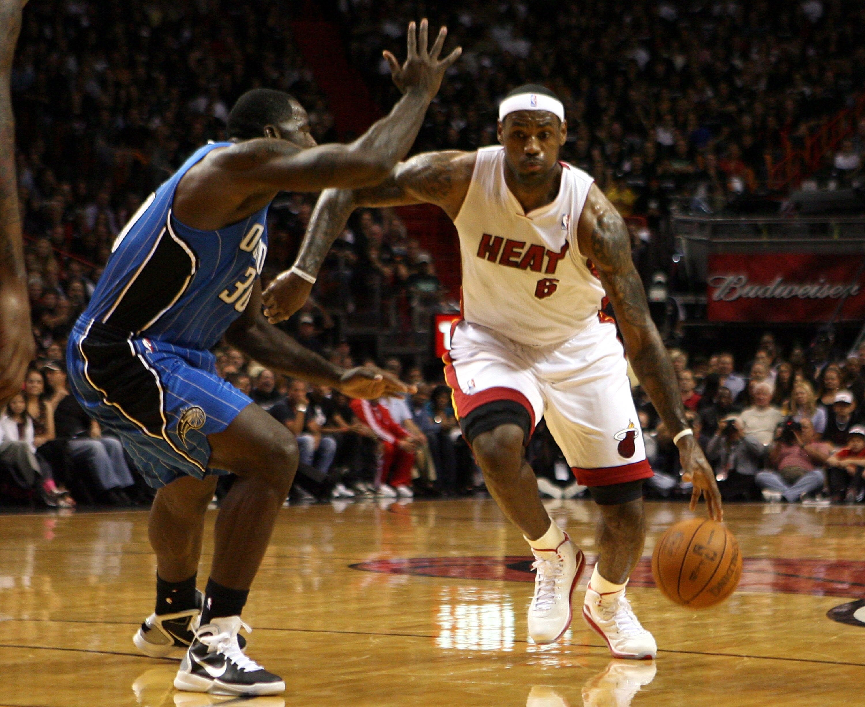 MIAMI - OCTOBER 29:  Forward LeBron James #6 of  the Miami Heat drives against forward Brandon Bass #30 of the Orlando Magic at American Airlines Arena on October 29, 2010 in Miami, Florida.  NOTE TO USER: User expressly acknowledges and agrees that, by d