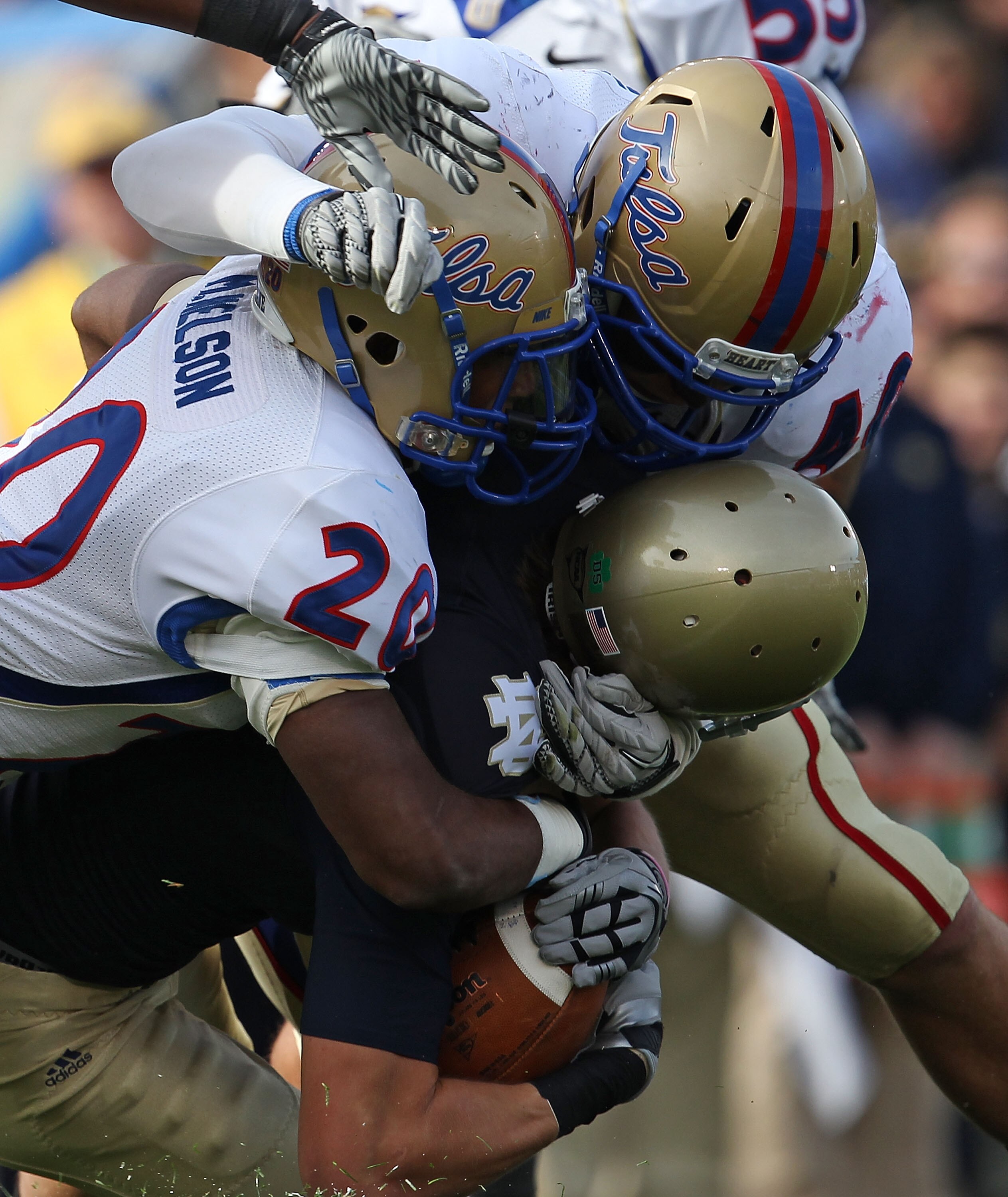 SOUTH BEND, IN - OCTOBER 30: John Goodman #81 of the Notre Dame Fighting Irish is tackled by Marco Nelson #20 and Tanner Antle #40 of the Tulsa Golden Hurricane at Notre Dame Stadium on October 30, 2010 in South Bend, Indiana. (Photo by Jonathan Daniel/Ge