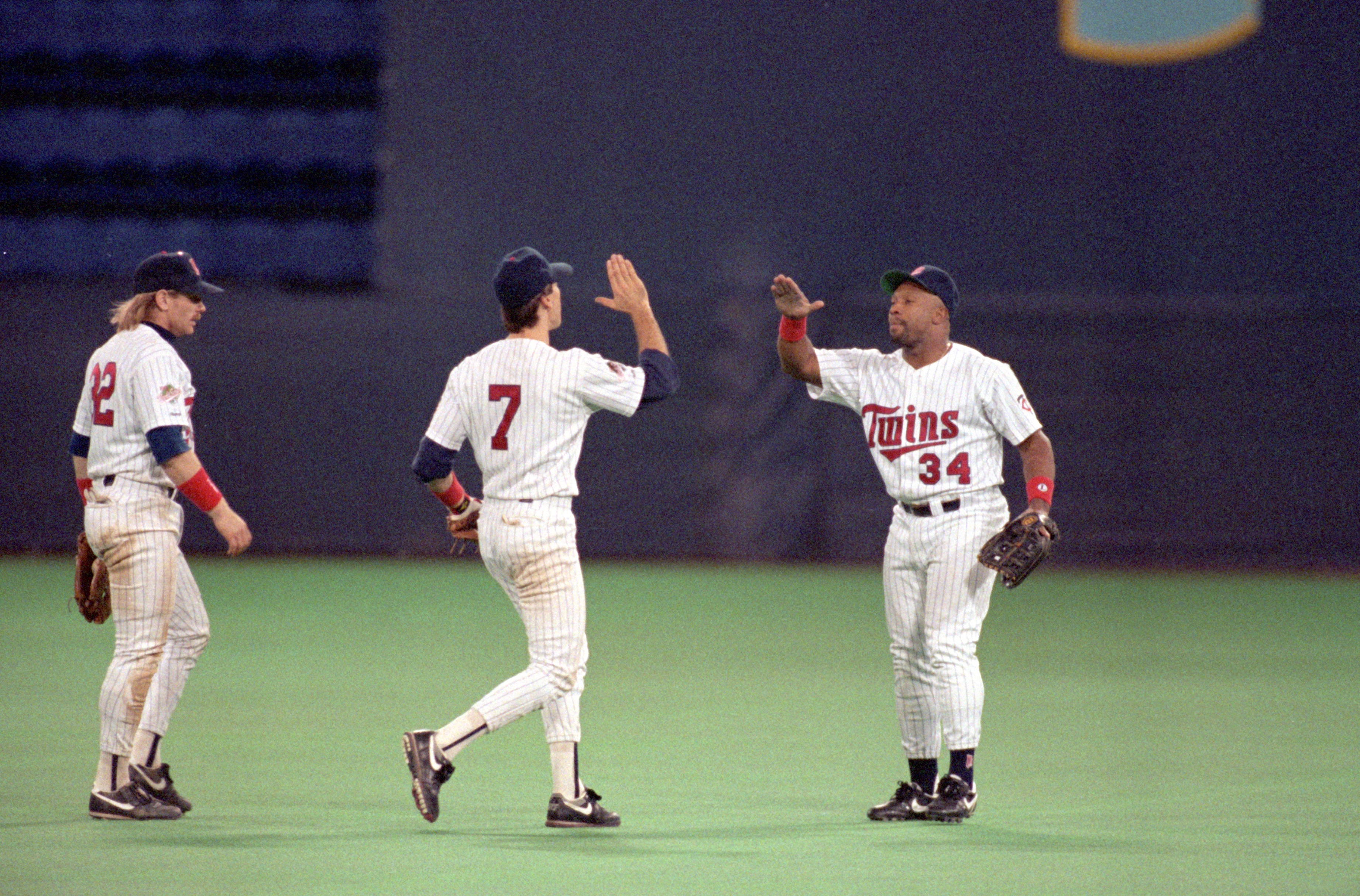 MINNEAPOLIS - OCTOBER 19:  Kirby Puckett #34 and Greg Gagne #7 of the Minnesota Twins high five while Dan Gladden #32 looks on during Game one of the 1991 World Series against the Atlanta Braves at the Metrodome on October 19, 1991 in Minneapolis, Minneso