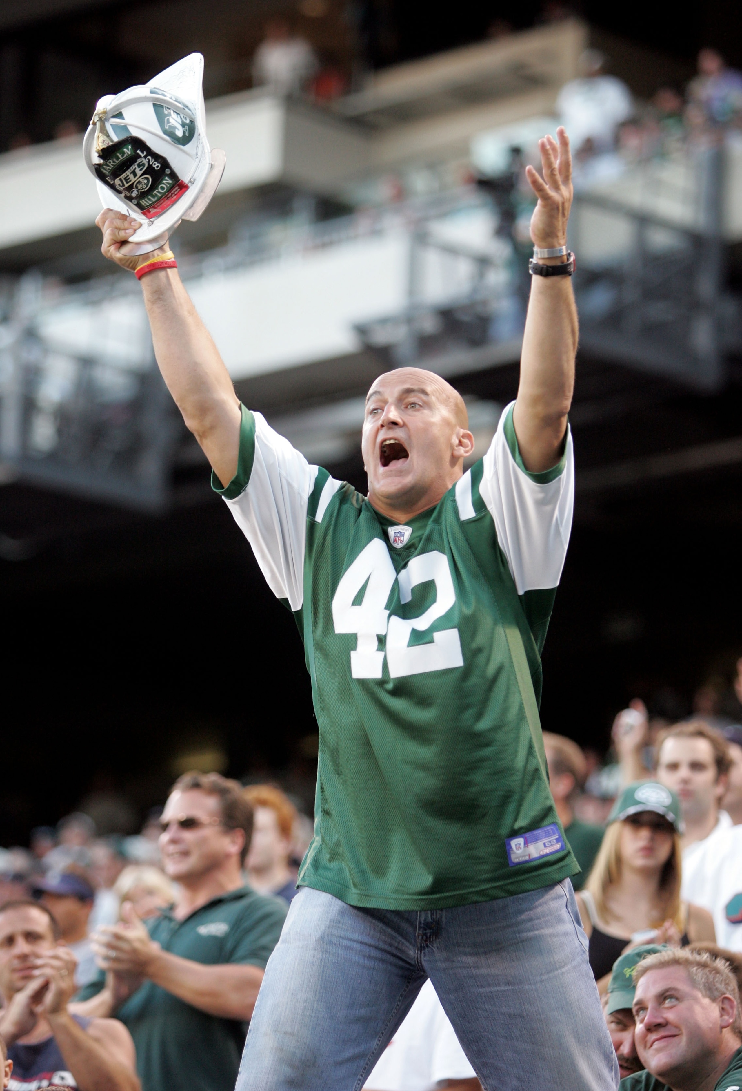 EAST RUTHERFORD, NJ - SEPTEMBER 18:  New York Jets fan 'Fireman' Ed Anzalone tries to fire up the crowd during the Jets game against the Miami Dolphins on September 18, 2005 at Giants Stadium in East Rutherford, New Jersey. The Jets defeated the Dolphins