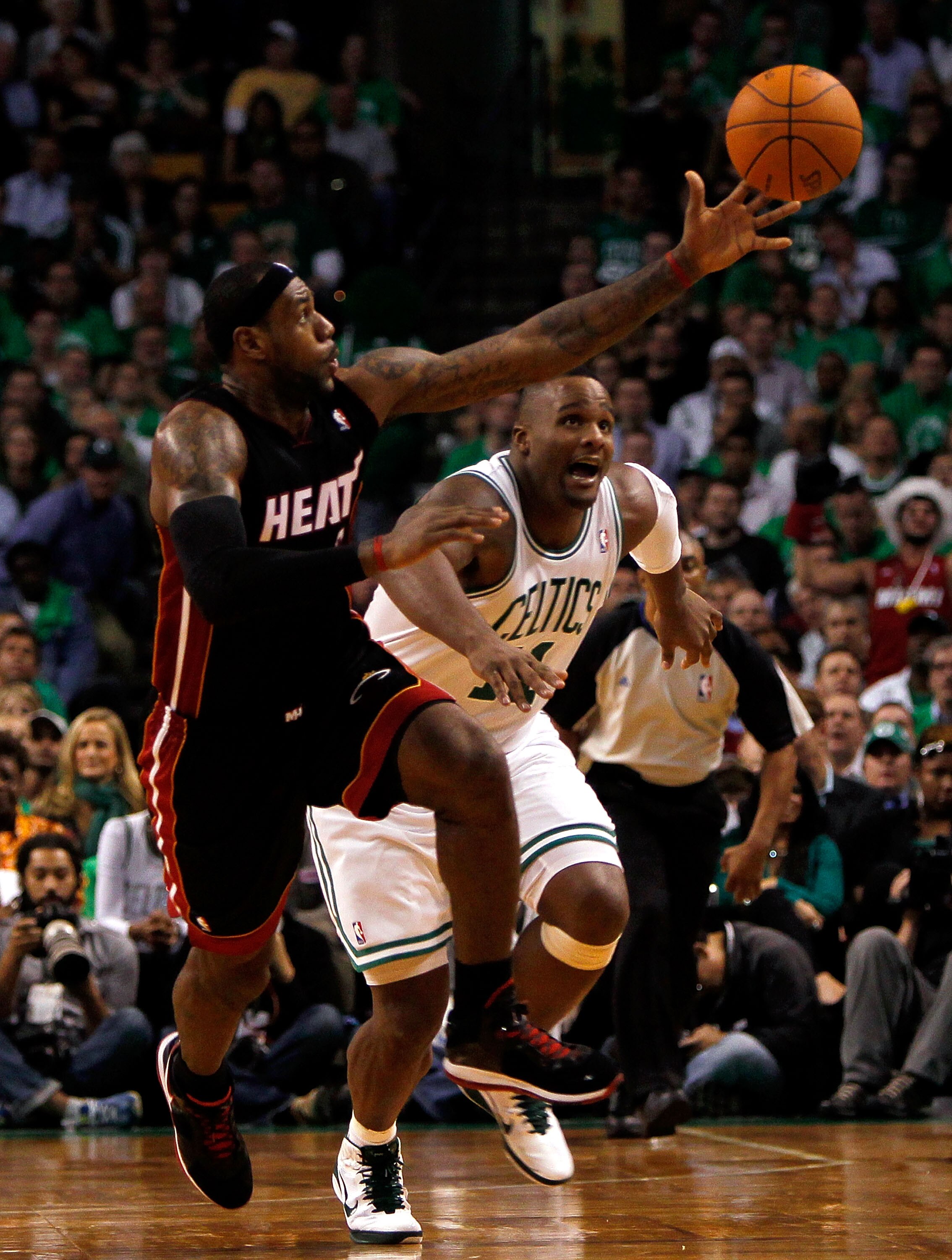 BOSTON, MA - OCTOBER 26:  LeBron James #6 of the Miami Heat beats Glen Davis #11 of the Boston Celtics to a loose ball at the TD Banknorth Garden on October 26, 2010 in Boston, Massachusetts. NOTE TO USER: User expressly acknowledges and agrees that, by d