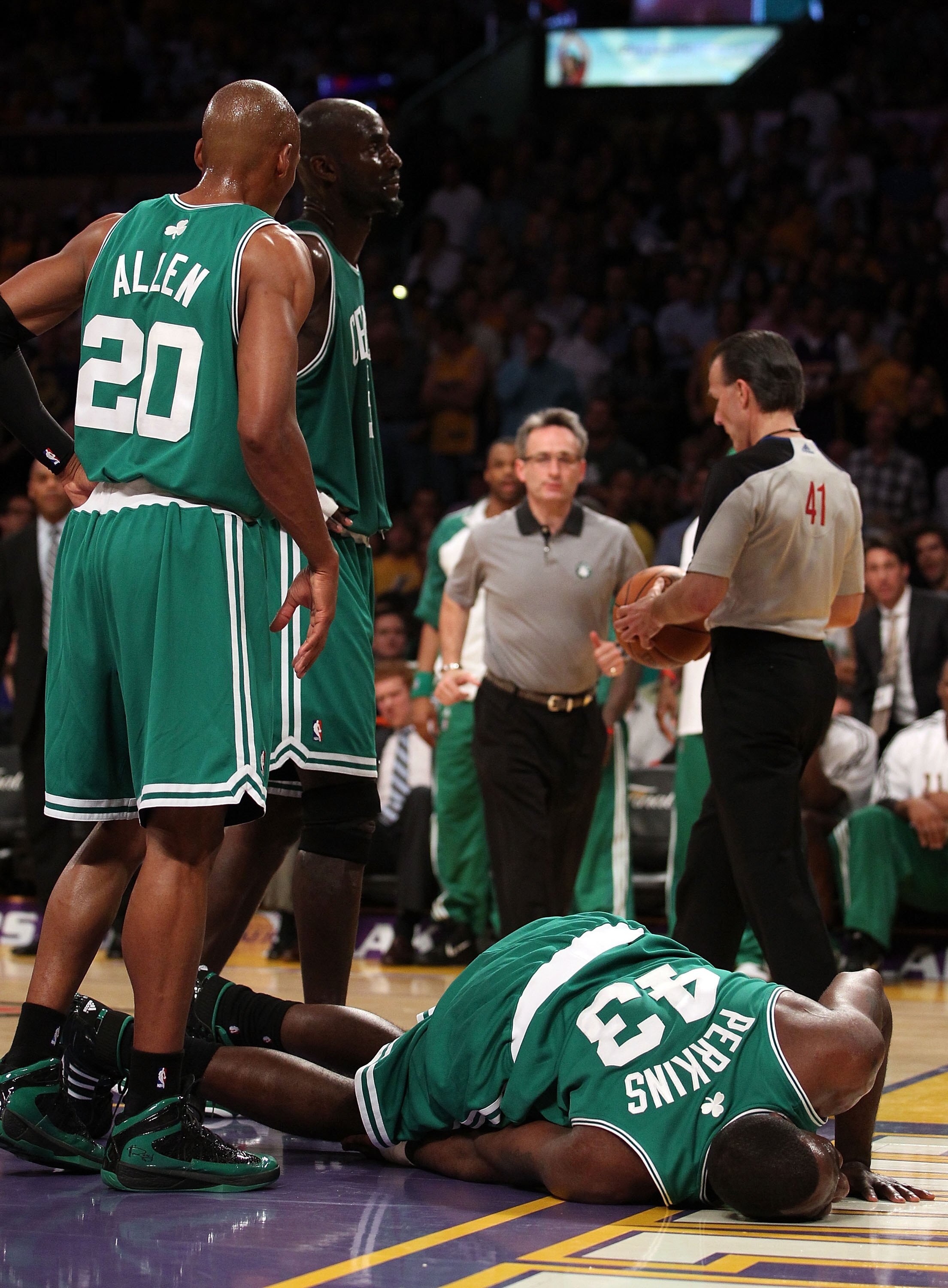 LOS ANGELES, CA - JUNE 15:  Kendrick Perkins #43 of the Boston Celtics is attended to by the trainer in the first half against the Los Angeles Lakers in Game Six of the 2010 NBA Finals at Staples Center on June 15, 2010 in Los Angeles, California.  NOTE T