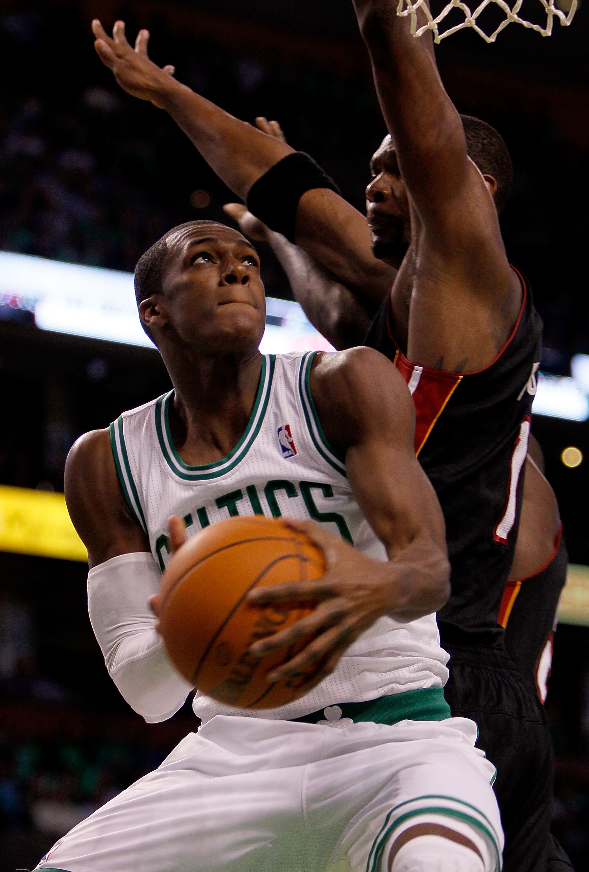 BOSTON, MA - OCTOBER 26: Rajon Rondo #9 of the Boston Celtics beats Chris Bosh #1 of the Miami Heatto the basket at the TD Banknorth Garden on October 26, 2010 in Boston, Massachusetts. NOTE TO USER: User expressly acknowledges and agrees that, by downloa