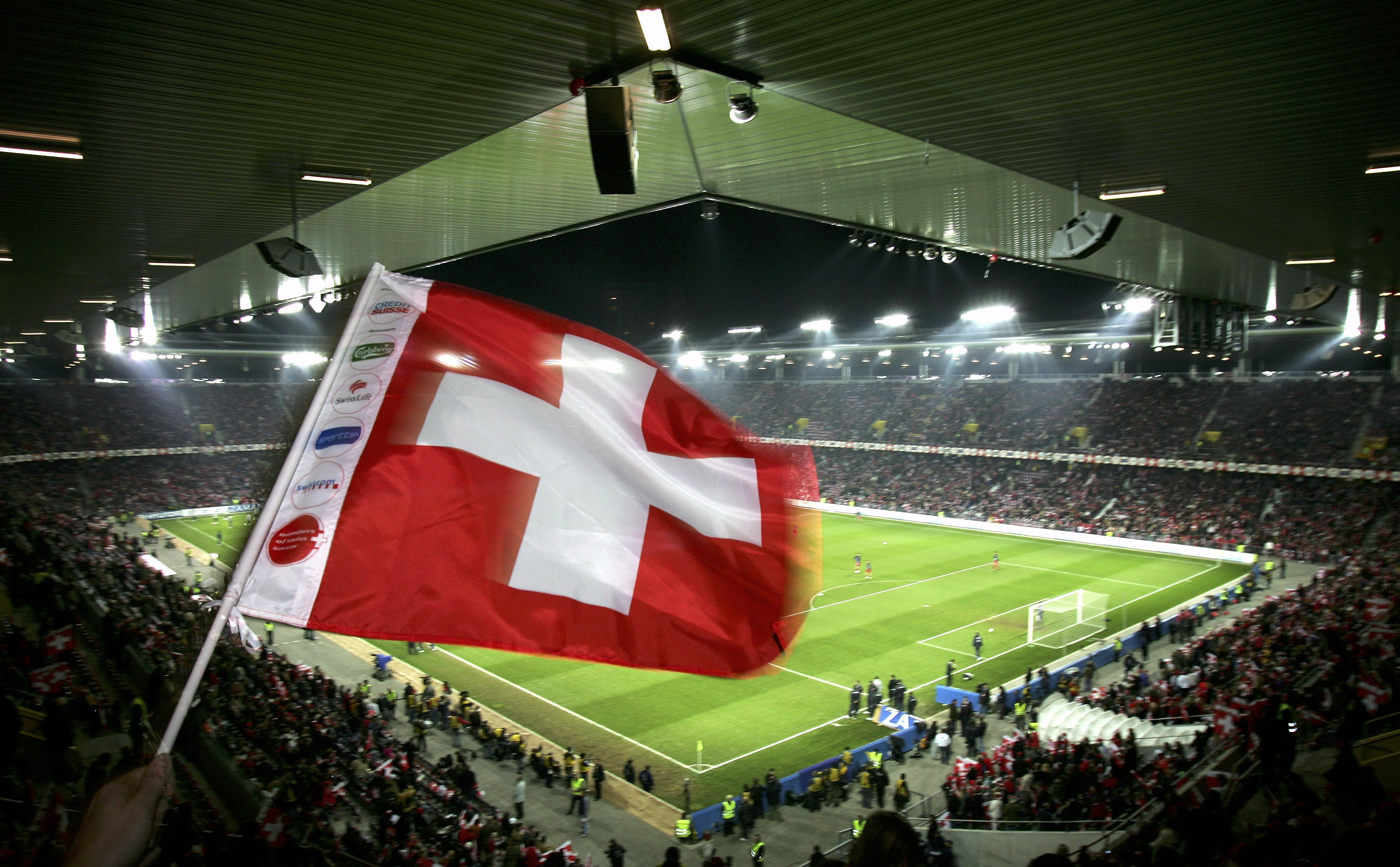BERN, SWITZERLAND - NOVEMBER 12:  A Swiss football fan waves his flag during The Football World Cup Qualification play-off  match between Switzerland and Turkey at Stad De Suisse on November 12, 2005 in Bern, Switzerland.  (Photo by Stuart Franklin/Getty