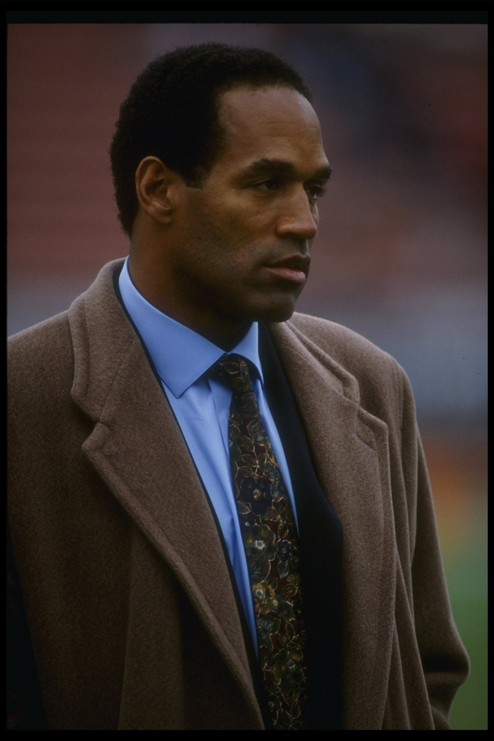 8 Dec 1991:  NBC reporter O.J. Simpson looks on during a game between the Los Angeles Raiders and the Buffalo Bills at the Coliseum in Los Angeles, California.  The Bills won the game, 30-27. Mandatory Credit: Gary Newkirk  /Allsport