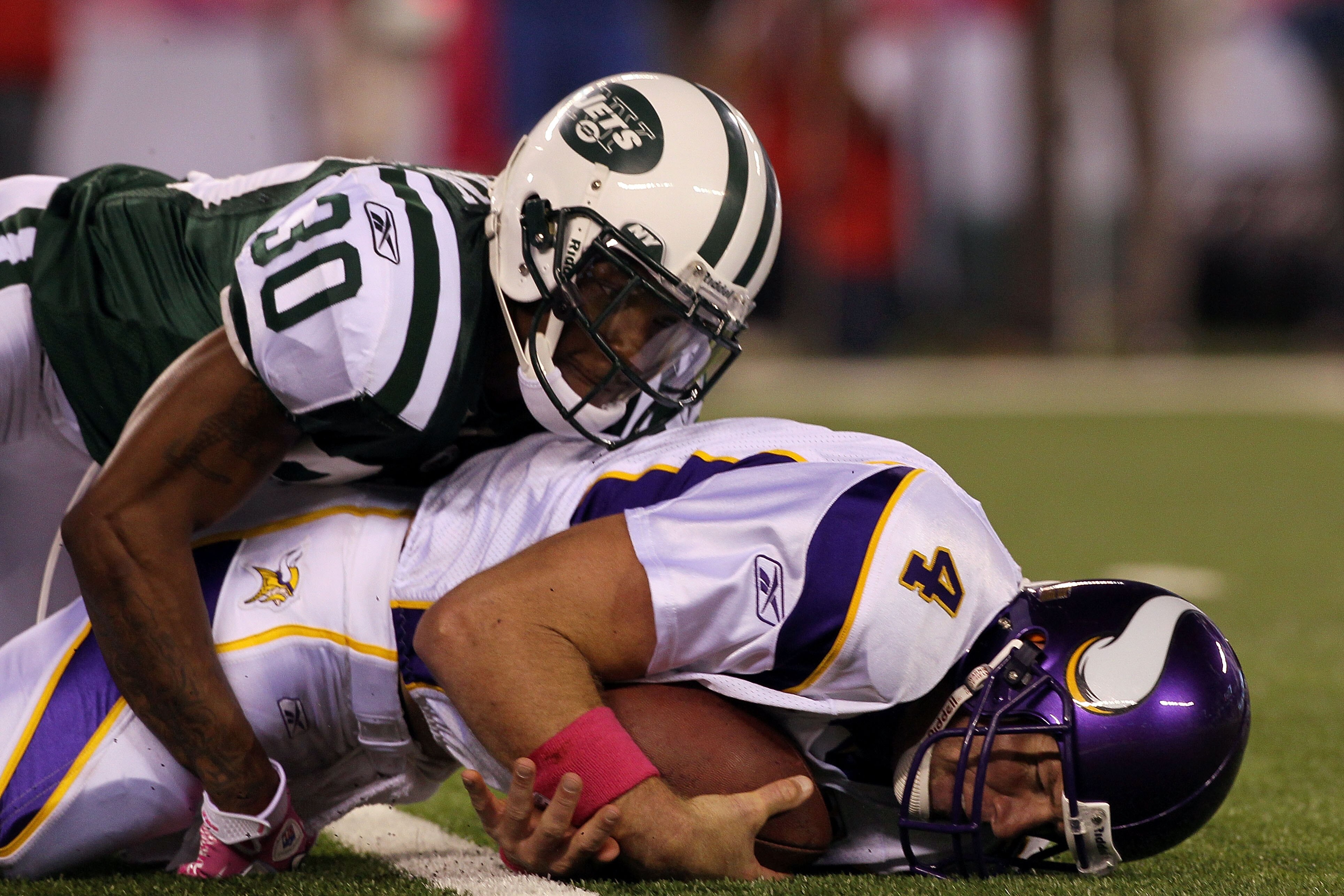 EAST RUTHERFORD, NJ - OCTOBER 11:  Drew Coleman #30 of the New York Jets sakcs quarterback Brett Favre #4 of the Minnesota Vikings in the first half at New Meadowlands Stadium on October 11, 2010 in East Rutherford, New Jersey.  (Photo by Jim McIsaac/Gett