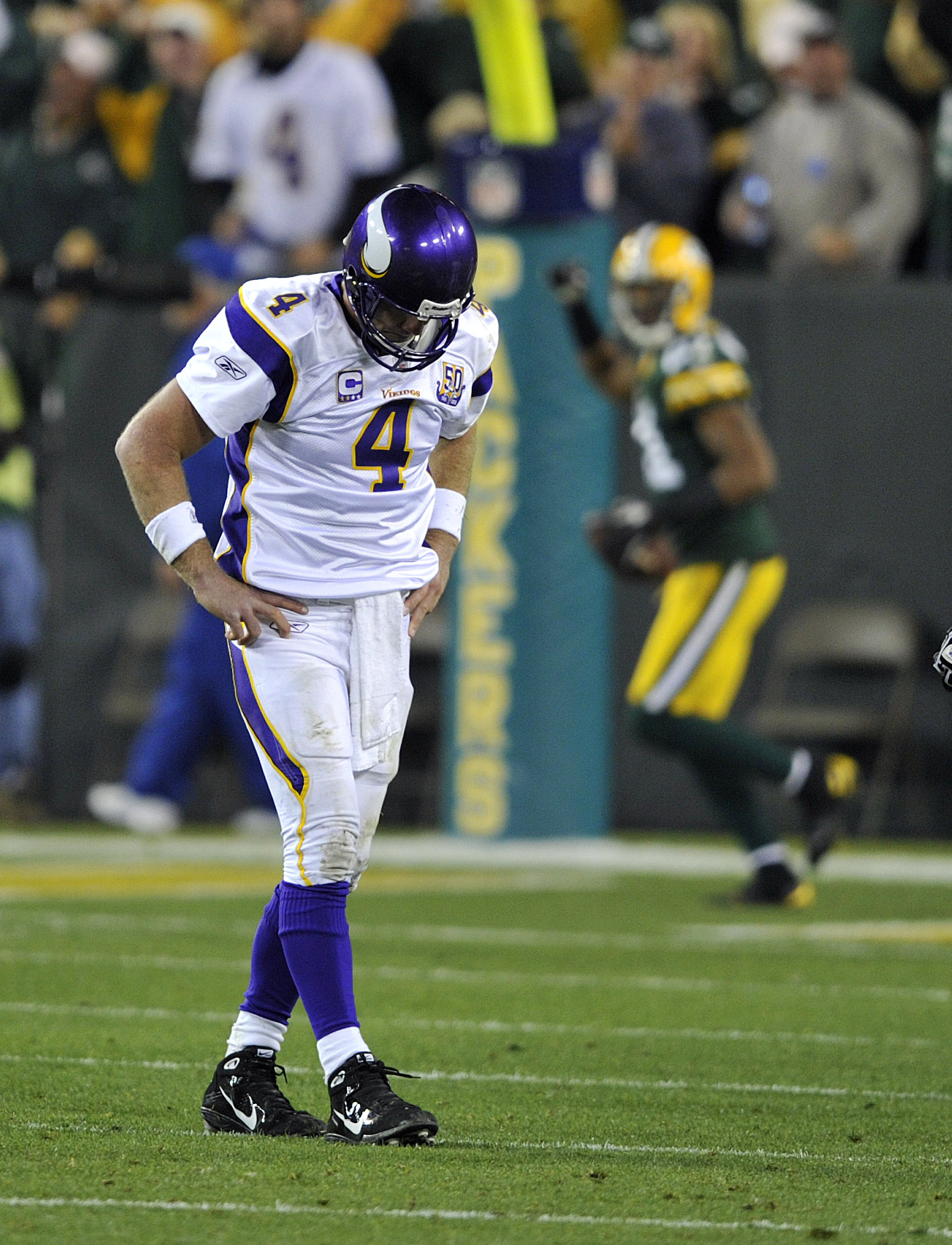 GREEN BAY, WI - OCTOBER 24:  Brett Favre #4 of the Minnesota Vikings reacts as Desmond Bishop #55 of the Green Bay Packers celebrates his interception for a touchdown at Lambeau Field on October 24, 2010 in Green Bay, Wisconsin. (Photo by Jim Prisching/Ge