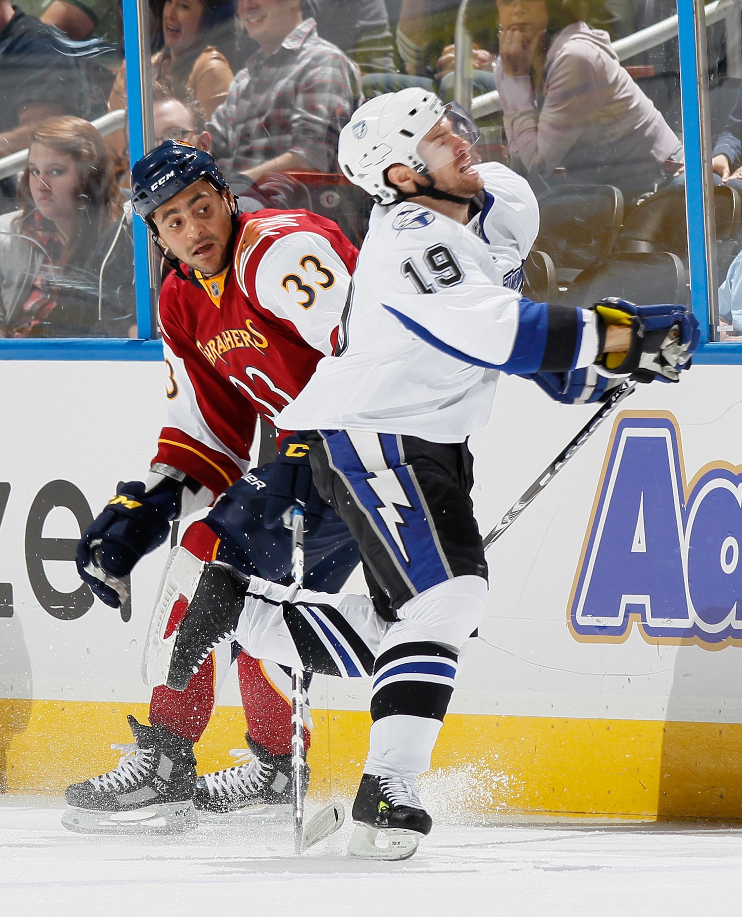 ATLANTA - OCTOBER 22:  Dominic Moore #19 of the Tampa Bay Lightning is penalized for taking a dive as he skates over the stick of Dustin Byfuglien #33 of the Atlanta Thrasher at Philips Arena on October 22, 2010 in Atlanta, Georgia.  (Photo by Kevin C. Co