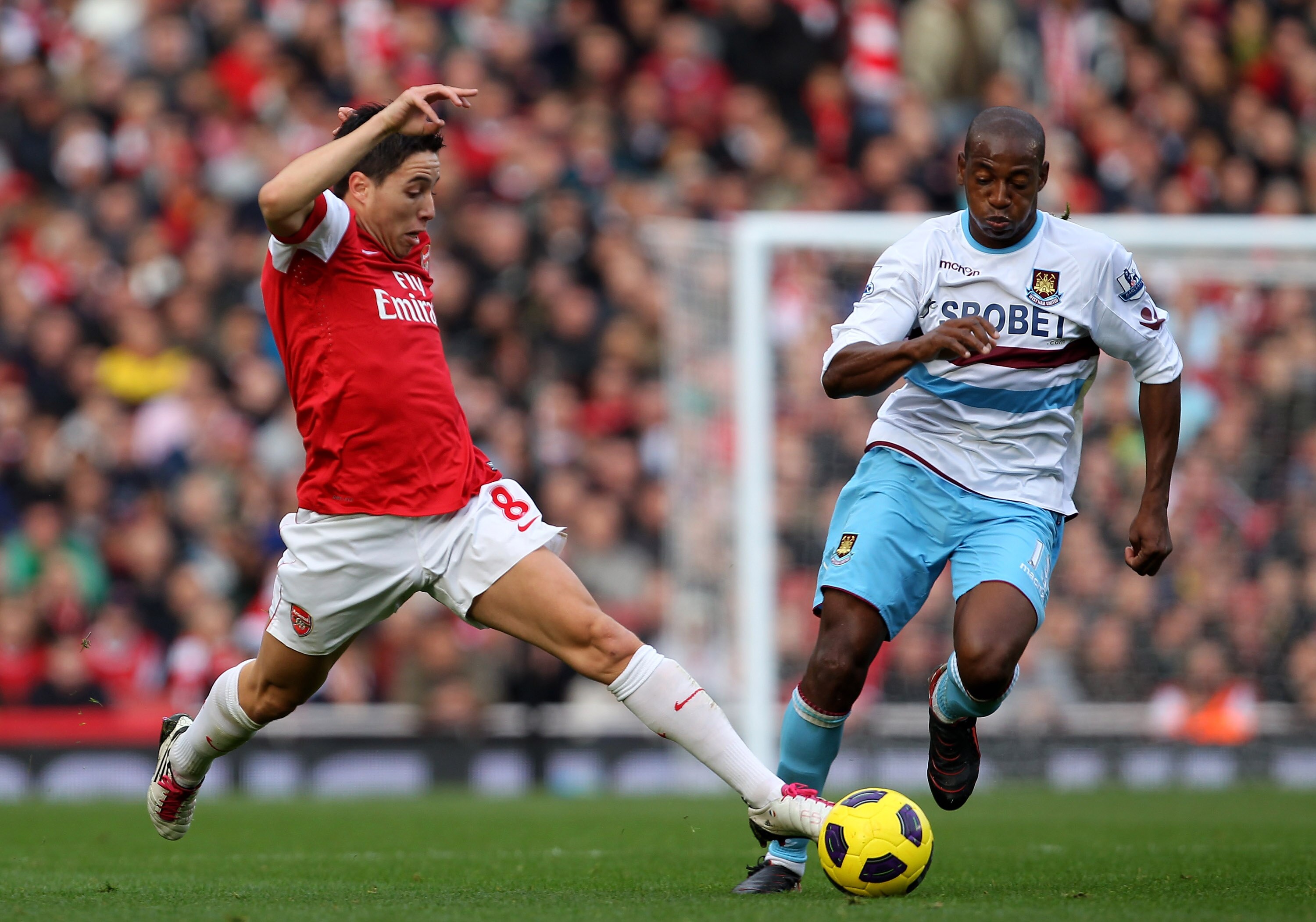 LONDON, ENGLAND - OCTOBER 30:  Samir Nasri of Arsenal fights for the ball with Luis Boa Morte of West Ham during the Barclays Premier League match between Arsenal and West Ham United at Emirates Stadium on October 30, 2010 in London, England.  (Photo by C