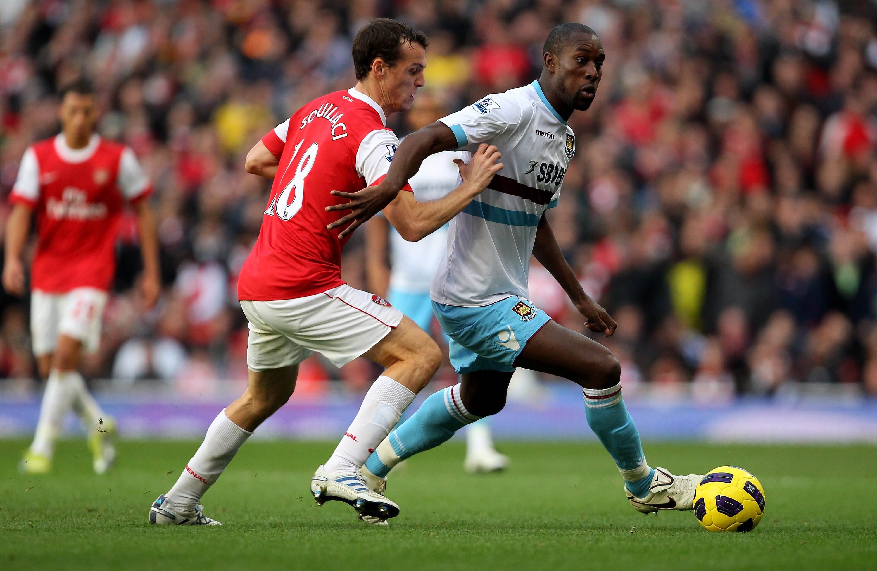 LONDON, ENGLAND - OCTOBER 30: Sebastien Squillaci of Arsebal challenges Carlton Cole during the Barclays Premier League match between Arsenal and West Ham United at Emirates Stadium on October 30, 2010 in London, England.  (Photo by Clive Rose/Getty Image